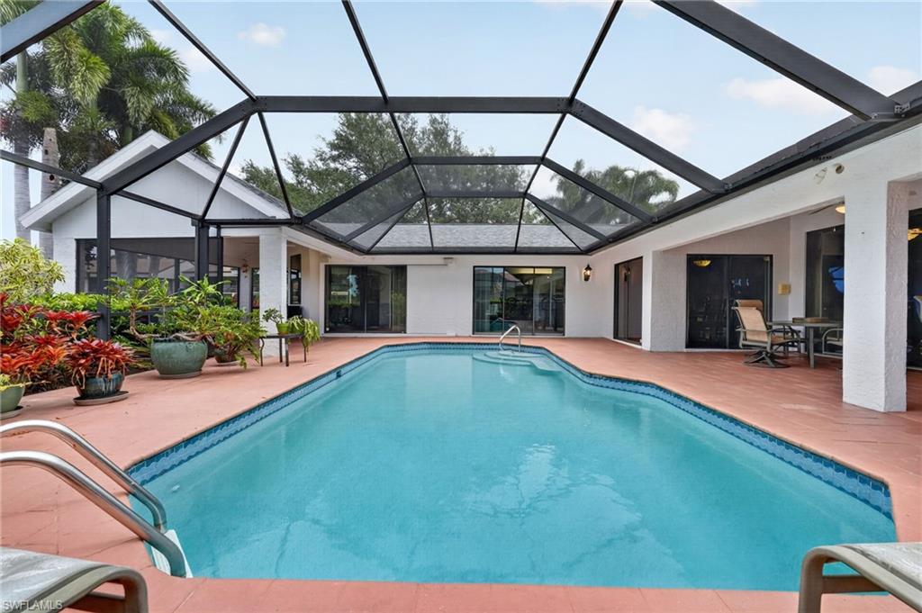 THIS POOL HOME HAS VIEWS GALORE - SUNSETS overlook the 8th hole of the golf course, 2 sparkling ponds & lush tropical landscaping. Attractively priced in the $500k's and partially furnished, it's ready for you to enjoy paradise living now! With almost 2,800 sq ft under air and 3,198 sq ft of total indoor/outdoor living space, this home offers 4 bedrooms, 2 1/2 baths, and a 2-car garage with storage. Five sets of sliding glass doors seamlessly intermingle the indoors and outdoors, creating the perfect setting for entertaining. The enclosed pool area features a covered lanai, bar area, and pool bath. The owners retreat offers an ensuite bath with separate vanities and a soaking tub. The white kitchen features a counter-height island with seating and opens to the family room with a vaulted ceiling. Enjoy meals in the formal dining room, breakfast nook, or dine alfresco. Nestled among lush landscaping. Freshly painted interior with white hues, the open floor plan and expansive views from nearly every window bring in abundant natural light throughout the home. Located in the highly desirable Eagle Ridge community, just off Daniels Parkway, this home offers easy access to shopping, restaurants, entertainment, RSW International Airport, and Southwest Florida's beautiful beaches. Surrounded by an 18-hole public championship golf course, residents enjoy a "pay as you play" lifestyle with no mandatory membership. Plus, LOW HOA fees of just $722 A YEAR (approximately $60 per month) include high-speed fiber optic internet.