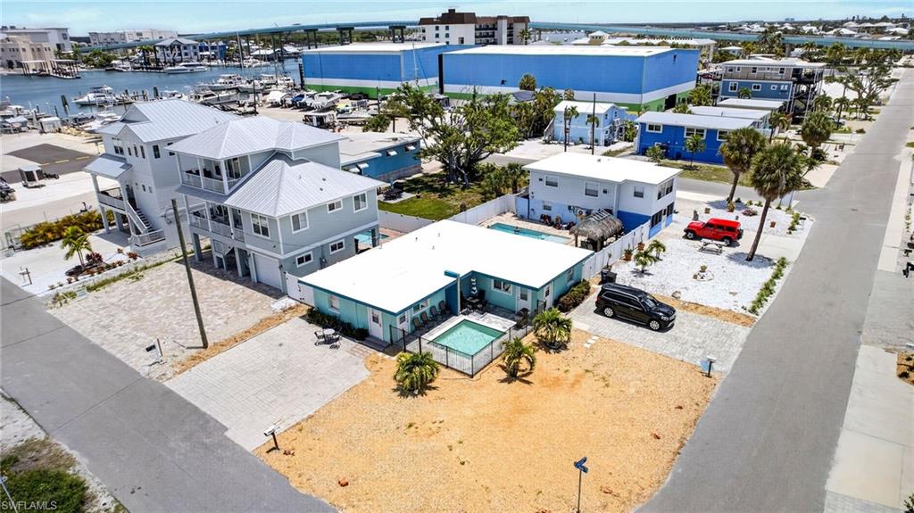 !!!NEW POOL 1 MONTH OLD!!! GREAT RENTAL INCOME with over 100K plus a year. This Rare opportunity to own a TWO Bedroom, one bath home with a TWO Bedroom, one bath apartment (aka 4/2 ZONED DUPLEX) on a Weekly Rental Zoned street in the sought after North End of Estero Island right in the heart of the (Town of Fort Myers Beach) off Old San Carlos Blvd. Two electric meters, one water meter. Shared laundry room, where both units have been 100% redone all with brand NEW interior. These units are rented almost weekly. This desirable neighborhood is just steps away from the bay, the beach, amazing restaurants, local bars, shopping, Time Square, public parks, public pier (when rebuilt), resorts, marina, boating, fishing and so much more - yet far enough away to quietly watch the sunset from your private pool courtyard. Rent them both out, Live in one, rent the other, live in both, the options are yours to choose.