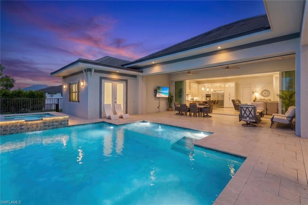 Welcome to luxury living at its finest! This exceptional 5 bedroom / Office , 4-bath residence showcases an expansive open floor plan, soaring volume ceilings, and seamless indoor-outdoor living designed for both everyday comfort and unforgettable entertaining. Built by award winning Windward homes. 

The heart of the home is a stunning chef's kitchen featuring custom cabinetry, a full-size refrigerator and separate full-size freezer, built-in cooktop, oversized center island with breakfast bar seating, and abundant prep and storage space. The spacious living area opens effortlessly through dramatic accordion sliding glass doors to an enormous covered lanai, creating the perfect extension of your living space.

Step outside to your private backyard oasis featuring a resort-style pool and spa with a relaxing sun shelf, outdoor kitchen, and massive covered entertaining area - 868 square feet . Mature hedges  provide exceptional privacy, making this the ideal setting to relax or entertain guests.

The luxurious primary suite offers a true retreat with dual walk-in closets and a spa-inspired ensuite featuring dual vanities and an oversized walk-in shower with dual shower heads. 

Additional highlights include a paver driveway, spacious 3-car garage, and premium finishes throughout. Home sits on a 4 lot site and is 160 ft wide x 125 feet deep with a huge yard. With estimated 40 feet on the sides there is plenty or room to add an addition or park a boat. This extraordinary home combines sophisticated design, exceptional craftsmanship, and resort-style amenities to create the ultimate Florida lifestyle.