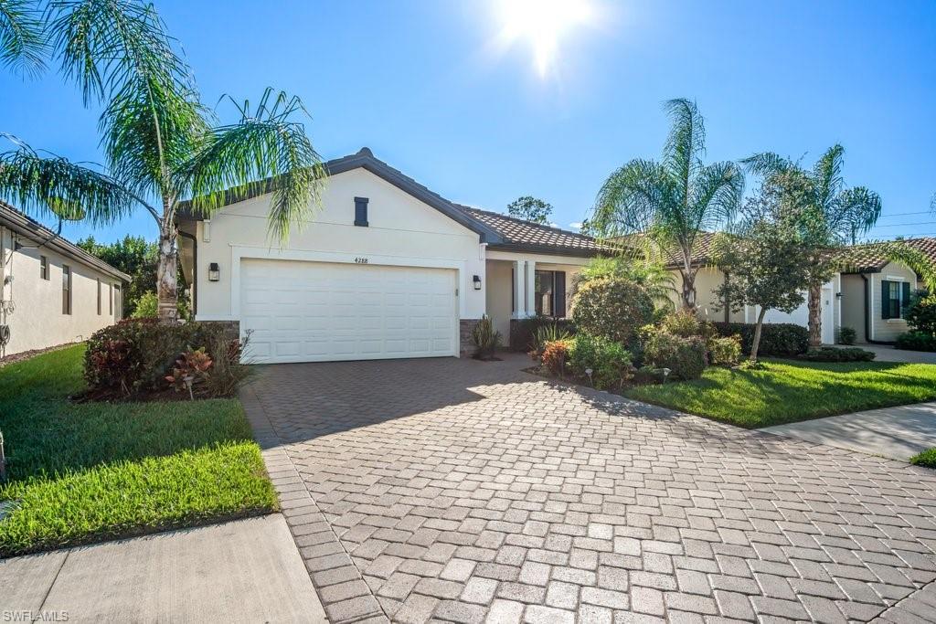 THIS HOME SHOWS LIKE A MODEL! Built in 2018, this stunning Raffia Preserve 3 bedroom and 3 bathroom home is a must see!  High ceilings, light and bright, white kitchen cabinets, granite counters, stainless steel appliances, tile floors, huge sliding patio door out to your covered and screened Lanai with plenty of room for a POOL!  High-end upgraded finishes include custom built-in entertainment center, crown molding and LED canned lighting throughout.  The Garage is finished like a show room for the car & tool enthusiasts or whenever extra space is needed, with epoxy floors and a full professionally installed secondary split A/C system.  Raffia Preserve one of the most highly desirable neighborhoods in one of the Top Rated school districts, with community access from both Vanderbilt Beach Rd. and Collier Blvd.  Perfect for all Lifestyles, Raffia Preserve boasts a breathtaking Resort Style Pool, Playground, Basketball Court, a 2,000 square foot State of the Art Fitness Center, and huge Clubhouse with Activity Room. 8 Miles to Vanderbilt Beach and Minutes to I-75!