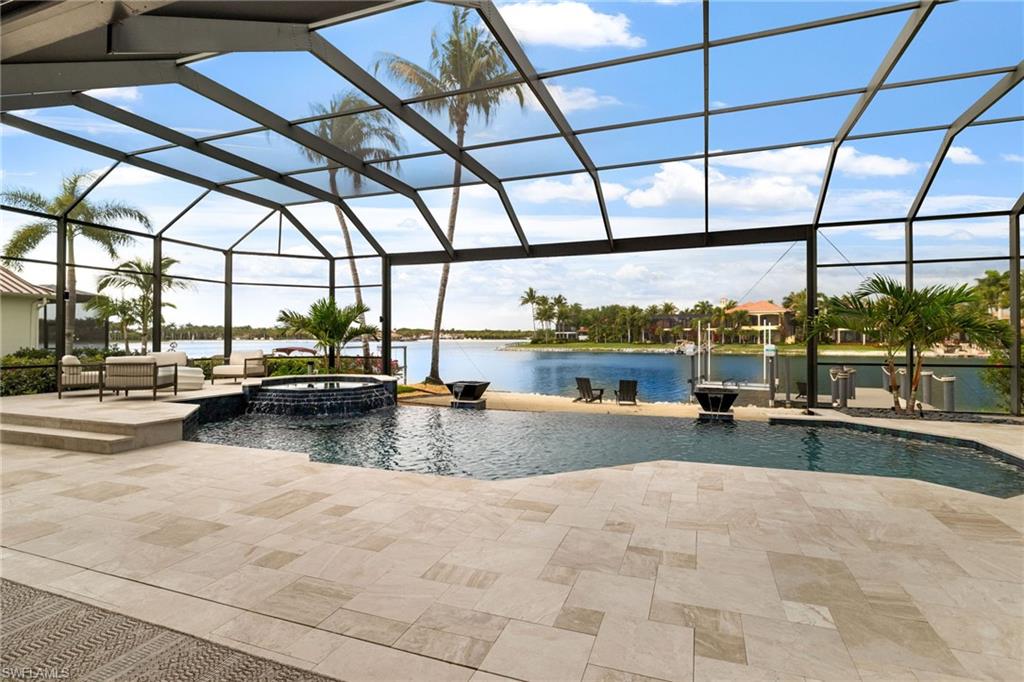 Come experience perfection at Miromar Lakes Beach and Golf Club. Every inch of this home has been thoughtfully customized with impeccable attention to detail, featuring curated hardwood floors and custom wood beams, designer selected furnishings, lighting, linens, custom cabinetry and hardware throughout, the chef's kitchen has been completely redesigned with high end appliances and cabinetry blending elegance and functionality. New roof, air conditioning, hot water heater, electric hurricane shutters, plumbing and wiring throughout.  This exceptional property offers a resort style outdoor experience with a custom pool, private beach, oversized boat dock and lift, and a fully equipped outdoor kitchen perfect for entertaining.  Miromar features 700 acres of fresh-water lakes, with boating, fishing, swimming, water skiing, 3 miles of sand beaches, Caribbean style beach grill, club house, full-service country club for evening dinning, pool, full-service spa, fitness center, golf, tennis, pickleball, volleyball, basketball, bocce, two marinas, boat rentals and many other luxurious amenities