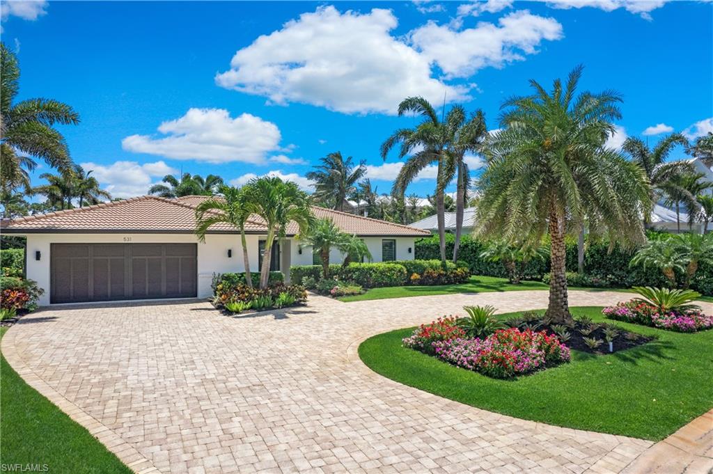 This striking single-story Park Shore ranch style home has been completely renovated and upgraded.  Featuring 3 expansive bedrooms plus a study and 2 full bathrooms, this home will captivate the most discerning of Buyers. Your chef’s dream kitchen with custom cabinetry and a large island features new Bosch appliances. The home features oak plank-flooring throughout except for tile in the bathrooms and an air conditioned garage. Impact resistant windows fill the home with natural light. Glass sliders seamlessly open the great room to the covered  and an outdoor living area perfectly equipped for entertaining. The exterior features include a large heated pool with shell stone and paver decking and an integrated spa. Lush, tropical landscaping surrounds the oversized .32 acre property and provides plenty of privacy. With a coveted location just steps away from The Waterside Shops, Venetian Village, world-class dining, entertainment and private white-sand Gulf beach access for Park Shore residents, you can truly enjoy SW Florida coastal living.