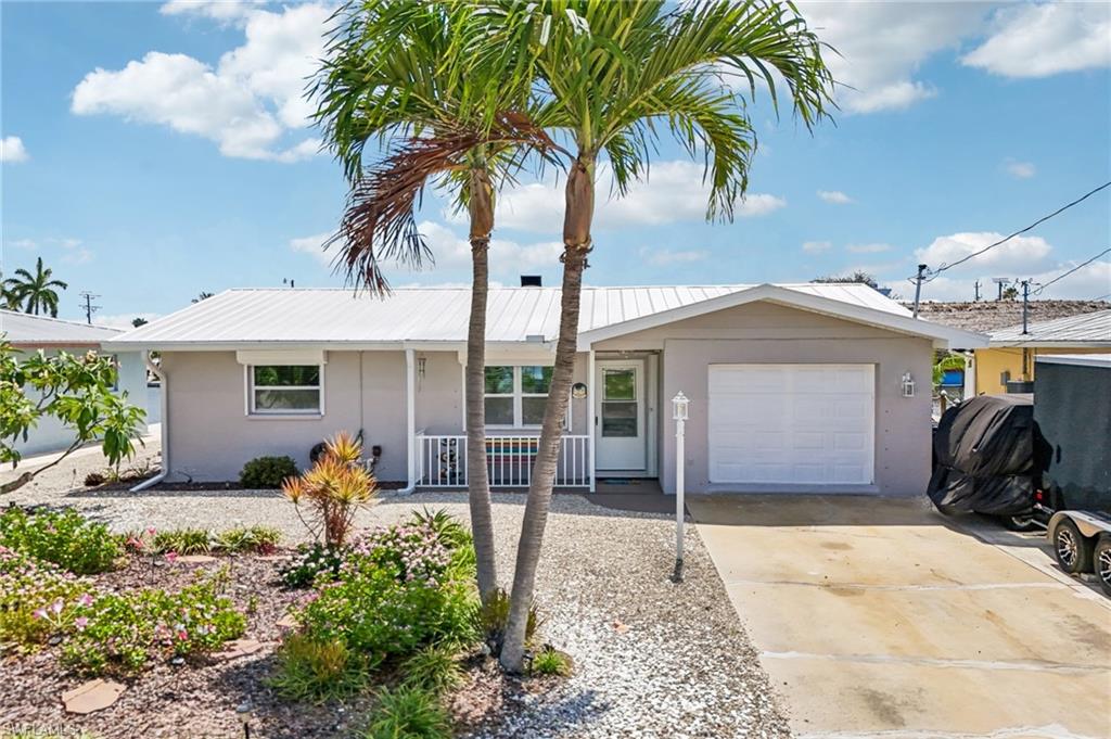 Boaters, anglers, investors, and island dreamers, this is the one. Welcome to your turnkey waterfront retreat on Monroe Canal in the heart of Saint James City offering direct boating access with no bridges to the intracoastal waterway. This property features a 5k pound boat lift, a 16k pound covered boat lift, and approximately 833 sq ft of dock/deck space designed for true island living. This beautifully updated 2 bedroom, 2 bath home also features a bonus bunk room/office, 1,300 sqft under air, a 300 sq ft screened lanai with outdoor shower, a large patio, and low-maintenance rocked yard. Inside, you’ll find an open layout, porcelain tile throughout, a spacious kitchen with large island, updated cabinetry, stainless appliances, inside laundry, and coastal furnishings that are negotiable and make the home feel bright, clean, and move-in ready. Major updates include plumbing in 2012, renovations in 2015 and 2022, metal roof in 2021, A/C and appliances in 2022, and drain field in 2020. A custom-built flood protection system by Flood Risk America with storage trailer is included, offering valuable peace of mind. Enjoy waterfront dining, fishing, kayaking, boating, and sunset evenings from your own private dock. Furnishings, hot tub, golf cart and select items negotiable separately. Call or text to schedule a showing.