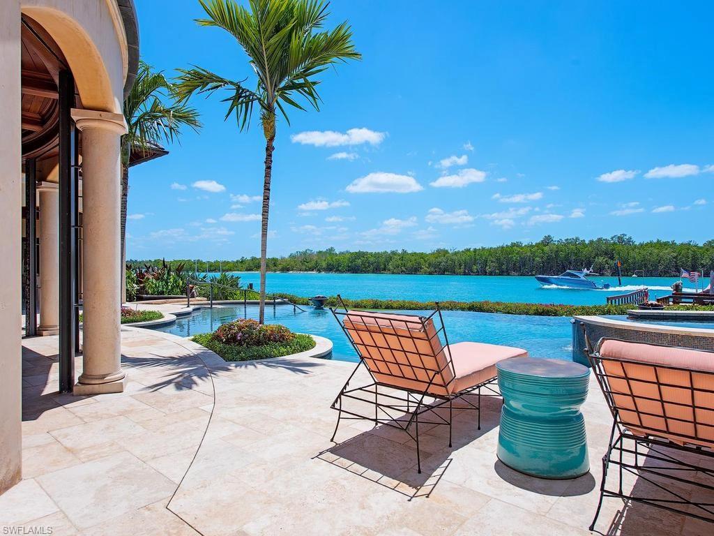 This custom waterfront residence boasts 194 ft. of water frontage on Admiralty Bay, in PortRoyal, offering full southern exposure and sweeping views with direct Gulf access. Unique architectural features include Venetian plaster, wood and stone floors, custom hand-made railings, and an iron elevator. The chef's kitchen is a culinary dream with three islands, barrel-vaulted brick ceilings, and commercial refrigerators. Seamless indoor-outdoor living is anchored by an infinity-edge pool and spa, complemented by a full outdoor kitchen featuring a stone fireplace and pizza oven.

The primary suite serves as a true owner's retreat with a sitting room, private balcony, and a luxurious spa bath finished in honey onyx that includes a steam shower with chromotherapy. Additional highlights include a private dock with lift, wine cellar, multiple fireplaces, and the anticipation of the spectacular new $100M clubhouse set to be completed in late 2026.

- 194 ft. of water frontage on Admiralty Bay
- Chef's kitchen with three islands and commercial appliances
- Infinity-edge pool and outdoor kitchen with pizza oven
- Private dock with lift for easy Gulf access
- Luxurious primary suite featuring honey onyx spa bath
- Wine cellar for connoisseurs
- Upcoming $100M clubhouse completion in late 2026
- Immediate Port Royal Club eligibility