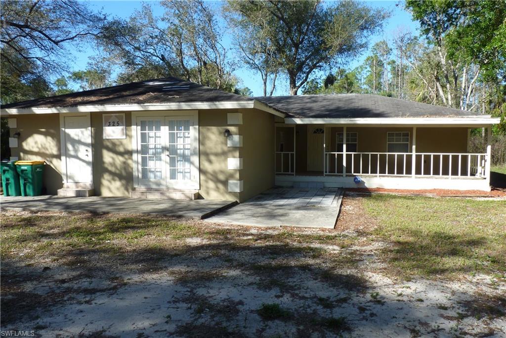 2.5 Acres ! Don't miss viewing this spacious and unique 3-4 bedroom+den home located on a beautiful 2.5 acre lot. The lot is nicely treed with a circular driveway, large front porch plus a large screened rear porch.  20x20 detached building. There are 4 bathrooms, a large laundry room, the living area offers an open concept with a great room, dining area, and center island kitchen.  This property offering is a nice value with its large home, beautiful 2.5 acre lot of land.  It is being sold AS-IS with the right to inspect. Proof of funds must be attached with the offer, as well as the pre-approval if obtaining financing.  6th Street is just 3 streets east of Wilson Blvd off Golden Gate Blvd, a convenient location to shopping and dining yet offers privacy and a beautiful large lot, in sunny NaplesFL .