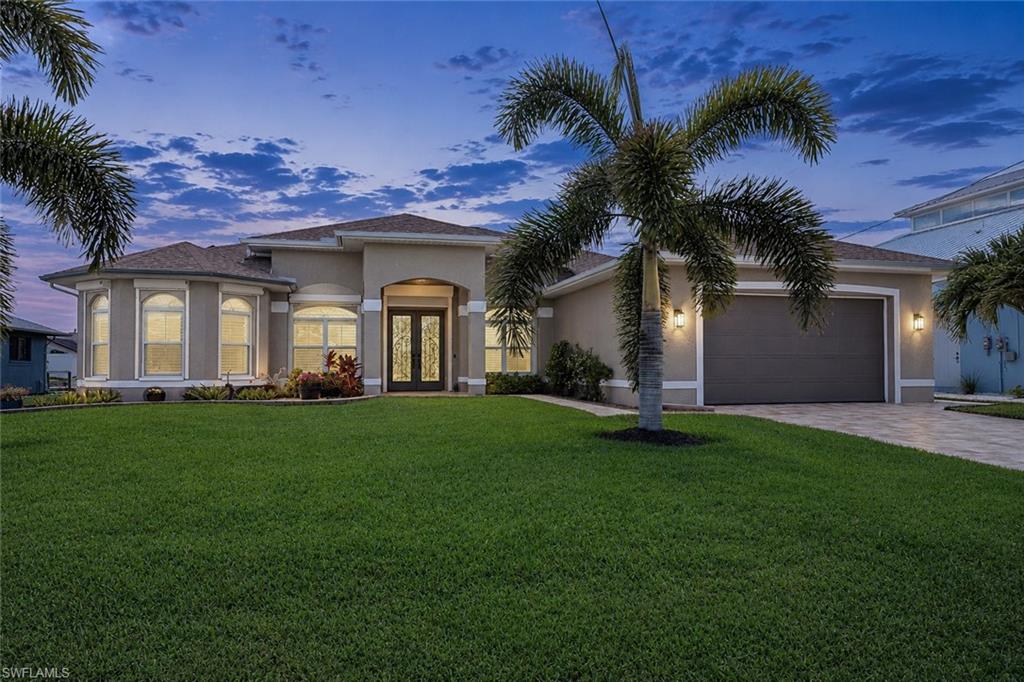 Direct Gulf access. No bridges. Expansive water views. Year-round sunsets. Perfectly positioned on the 180-foot-wide Alecia Canal with coveted SW exposure, this exceptional waterfront home combines unrestricted Gulf access, a hard-to-find 4 bed plus den, 3 bath floor plan, and an oversized 4-car garage. Measuring more than twice the width of many Cape Coral canals, the Alecia Canal offers exceptional maneuverability, accommodates everything from center consoles to large yachts, and provides spectacular sunsets nearly every evening. Designed for the waterfront lifestyle, the outdoor living area features a 31 Ft pool, oversized screened lanai, 30' x 33' dock, and 16,000-pound boat lift, making this home perfect for boating, fishing, entertaining, or simply relaxing by the water. Inside, the nearly 2,350 SF floor plan offers four bedrooms plus a private office with French doors that can easily serve as a fifth bedroom. Travertine flooring throughout, granite countertops in kitchen and baths, crown molding, plantation shutters, high-volume ceilings, and a stained-glass front entry complete the interior. The oversized 4-car garage comfortably fits three full-size vehicles while still leaving abundant room for storage, a workshop, golf carts, or recreational equipment, with flexibility for up to four vehicles depending on size. Major updates include a new roof (2020), A/C (2026), pool cage (2023), pool heater (2026), pool pump (2025), exterior paint (2023), interior paint (2025), and paver driveway and walkways (2026). Additional features include fully owned whole-house solar (July electric bill less than $63!) and complete, whole house hurricane protection including electric roll-down shutters on front door and rear lanai. A rare combination of direct Gulf access, a 180-foot-wide canal, versatile floor plan, oversized garage, and extensive updates makes this home stand out in today's waterfront market.
