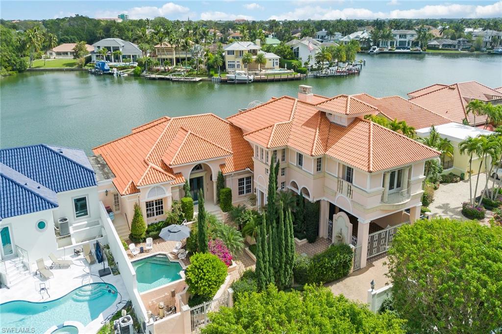 A rare opportunity awaits! This waterfront home is uniquely situated over Venetian Bay and just steps to the beach. Offering four bedrooms, a den and four-and-a-half baths, this extraordinary residence evokes European luxury throughout with its expansive private courtyard, custom interior details and beautiful terraces overlooking the bay. The home’s first floor features multiple gathering areas, whether it be the grand living room featuring a gas fireplace, the oversized formal dining room, which is perfect for entertaining or the inviting family room with beautiful bay views. The first floor also includes two en-suite guest bedrooms and a first-floor owner’s suite. The home’s second floor features a truly impressive owner’s retreat, complete with a large bedroom, a gas fireplace, two balconies, an expansive bath featuring dual water closets, a private sitting room and much more. Outside, one can relax poolside in the private courtyard with its lush landscaping and fountains or take in the gorgeous bay views outback from the wrap-around screened terrace. With private beach access across the street and Venetian Village just steps away, this distinctive home is sure to impress.