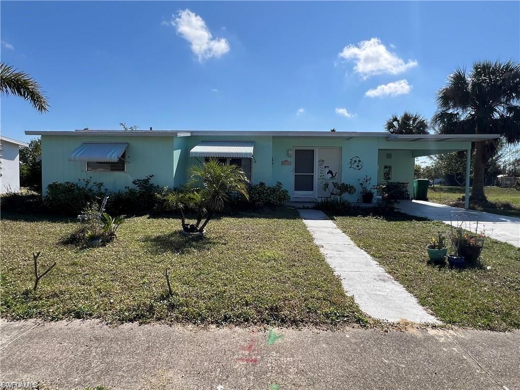 This adorable & cozy 2-bedroom home is perfectly located just minutes from I-75, shopping, hospitals, and top-rated schools! The soft green exterior, awning windows, and palm trees give it the perfect Florida charm. Inside, you'll find a bright & spacious living room with sliding glass doors leading to a screened lanai with vinyl windows—perfect for year-round enjoyment! The galley kitchen features white cabinetry, a breakfast bar, and a stylish backsplash. A separate dining area, vintage-style bathroom, and two comfortable bedrooms (one with a walk-in closet, the other with a built-in desk) complete the home. To mention a new roof and not in a Flood zone. Additional features include a laundry room, extra storage space, and a covered carport. Ideally situated near Sunseeker Resort, Punta Gorda Airport, and Southwest Florida's stunning beaches!