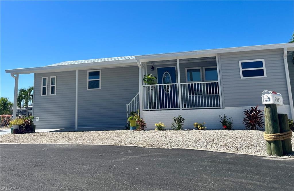 Skipper Lane In St James City !!! Cul-du-sac intersecting canals, 100' canal frontage, corner lot, very private, 2 bedroom, 2 bath, Living room Boat dock, Lift & boat house!!! .... Impeccable condition! Newley renovated! 1100 sq ft living, 1912 total sq ft modular home, Living room with porch access, Split Bedrooms, Master suite with master bath, utility room Carport ... ALL THIS in Beautiful Cherry Estates at the south tip of Pine Island...Great access by boat to the gulf, only 10 minutes! An angler's paradise. 10,000 LP boat lift with removable canopy. Breathtaking views of sunset with a private wrap-around dock. Absolutely gorgeous!
