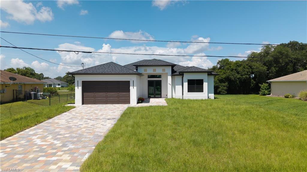 Brand-New Construction – Move-In Ready! Experience modern Florida living in this beautifully designed 4-bedroom, 2-bath home offering 2,676 total square feet with 1,882 square feet under air. Thoughtfully crafted with quality finishes and an open-concept floor plan, this home perfectly blends style, comfort, and functionality.
The bright and spacious living area features soaring ceilings, abundant natural light, and impact-resistant windows and doors throughout for added security, energy efficiency, and peace of mind. The designer kitchen showcases quartz countertops, custom cabinetry, and a complete stainless steel appliance package, including a refrigerator, range, microwave, and dishwasher, making it ideal for everyday living and entertaining.
The split-bedroom floor plan offers a private primary suite along with generously sized guest bedrooms and beautifully appointed bathrooms. Step outside to the full-length covered lanai, already designed with ample space for a future outdoor kitchen, creating the perfect setting to enjoy Southwest Florida's year-round outdoor lifestyle.
Additional upgrades include an asphalt shingle roof, paved driveway and front walkway, automatic garage door opener, exterior garage side entry door, irrigation sprinkler system, and quality craftsmanship with modern finishes throughout.
Conveniently located just 0.2 miles from State Road 82 and the new Fire Station, this home provides quick access to Fort Myers, shopping, dining, schools, parks, Southwest Florida International Airport, and all the conveniences of a rapidly growing community.
Whether you're looking for your primary residence, seasonal retreat, or investment property, this brand-new home offers exceptional value, quality construction, and a desirable location. Don't miss this opportunity—schedule your private showing today!