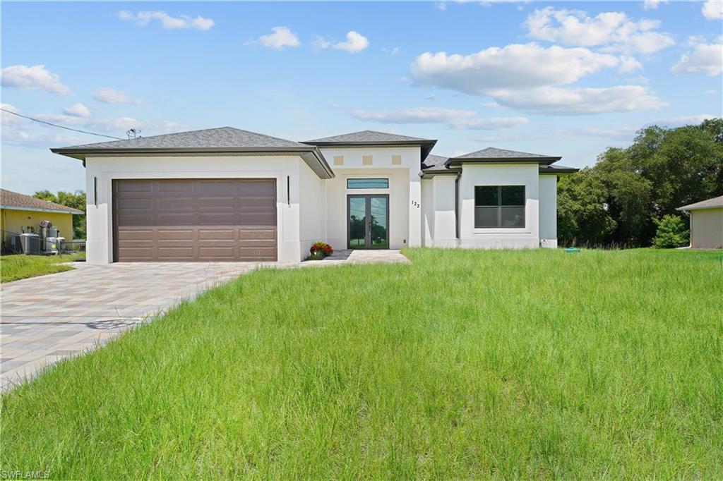 Brand-New Construction – Move-In Ready! Experience modern Florida living in this beautifully designed 4-bedroom, 2-bath home offering 2,676 total square feet with 1,882 square feet under air. Thoughtfully crafted with quality finishes and an open-concept floor plan, this home perfectly blends style, comfort, and functionality.
The bright and spacious living area features soaring ceilings, abundant natural light, and impact-resistant windows and doors throughout for added security, energy efficiency, and peace of mind. The designer kitchen showcases quartz countertops, custom cabinetry, and a complete stainless steel appliance package, including a refrigerator, range, microwave, and dishwasher, making it ideal for everyday living and entertaining.
The split-bedroom floor plan offers a private primary suite along with generously sized guest bedrooms and beautifully appointed bathrooms. Step outside to the full-length covered lanai, already designed with ample space for a future outdoor kitchen, creating the perfect setting to enjoy Southwest Florida's year-round outdoor lifestyle.
Additional upgrades include an asphalt shingle roof, paved driveway and front walkway, automatic garage door opener, exterior garage side entry door, irrigation sprinkler system, and quality craftsmanship with modern finishes throughout.
Conveniently located just 0.2 miles from State Road 82 and the new Fire Station, this home provides quick access to Fort Myers, shopping, dining, schools, parks, Southwest Florida International Airport, and all the conveniences of a rapidly growing community.
Whether you're looking for your primary residence, seasonal retreat, or investment property, this brand-new home offers exceptional value, quality construction, and a desirable location. Don't miss this opportunity—schedule your private showing today!