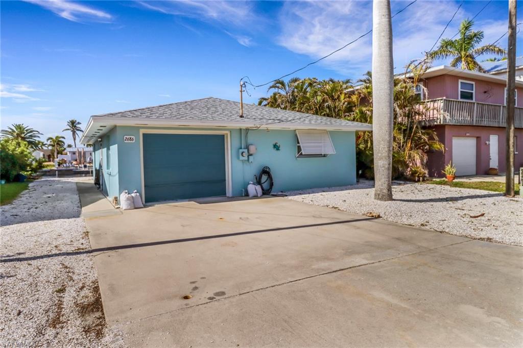 This 2 br, 1 bth home located in a small quaint community of gulf access waterfront homes in Matlacha.  This home is reasonably priced, just waiting for your finishing touches.  Major improvements already completed: New Composite Dock installed in 2024, New Roof in 2023, New A/C system in 2024 and New hot water heater in 2024.  Photos depict before and after to show the potential of how adorable you can decorate the home for your private use or make some extra bucks renting as a vacation rental. Come see this home today! Great Value and Opportunity.