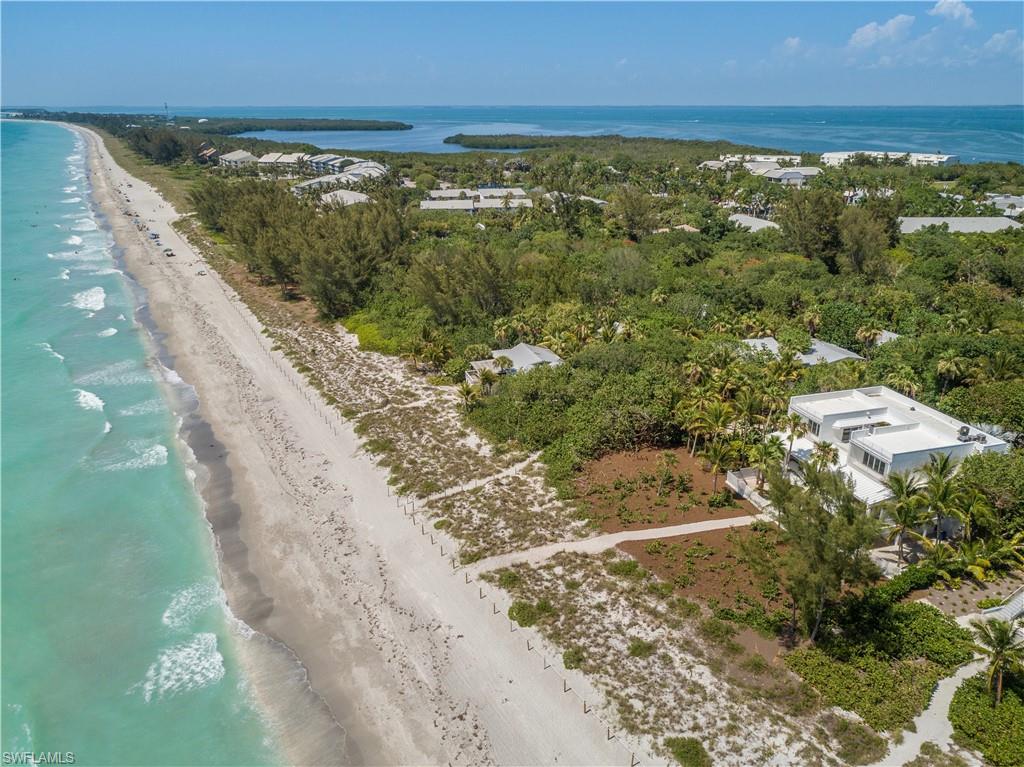 Stunning modern iconic beachfront estate on pristine Captiva Island. Created for & formally owned by a world renowned artist. The property sits on 7 individual lots w/lush vegetation & privacy. Featuring 5,000+ sq ft of AC space w/4 stories of unmatched & breathtaking views. Inside & outside you are awestruck w/the homes magnitude and energy. This luxurious estate boast 2 huge waterfront master suites w/private beachfront balconies along w/additional guest areas on each floor. Spectacular great room w/volume ceilings & huge floor to ceiling windows & sliders, open gourmet kitchen & lots of bonus space on all levels to relax, sleep & enjoy. The fabulous beach path is your own personal gateway to clear blue waters & spectacular sunsets. The property has played host to many celebrities & well known public figures. The village location ensures a relaxed island lifestyle w/short walks to dining and entertainment. This home was made for celebrating & w/legacy in mind, a home like no other!