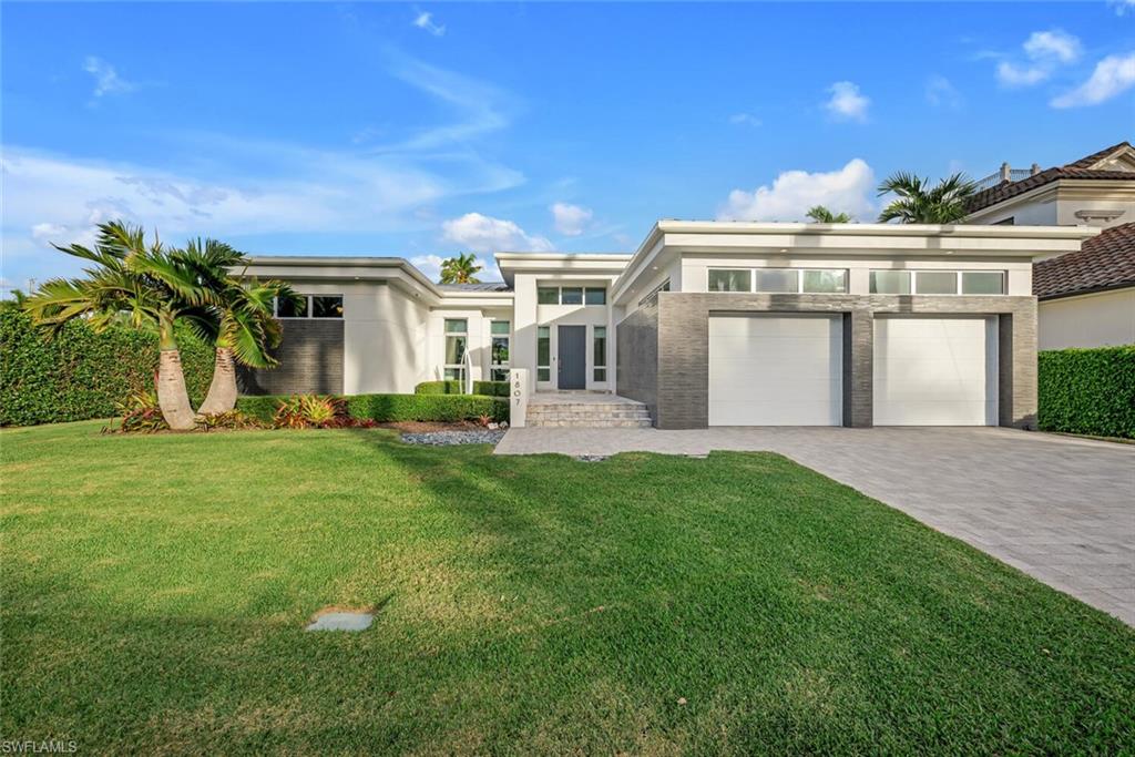 H4247 - This modern home located in the highly sought after boating community of Royal Harbor exemplifies magazine-worthy clean lines and geometric shapes. The four bedroom, three and a half bath home resides on a .38 acre lot overlooking the wide waterway opening into Naples Bay and the Gulf of Mexico. One will thoroughly enjoy living within the 3,306 square feet under air (4,043 total) open floor plan home featuring masterful stonework, high-end appliances, quartz countertops, and Hyland Custom Cabinetry throughout. The interior kitchen, outdoor summer kitchen, and pool area were specifically designed for the entertainer at heart. In addition, the home is equipped with a sleek oversized 2-car garage, Tesla charging station, and a generator hookup. The majority of the 111 foot seawall is lined with composite decking plus a 10,000 lb boat lift that will accommodate a 32 foot vessel. All just minutes from Downtown Naples' upscale shopping, 5-star dining, and beautiful beaches!