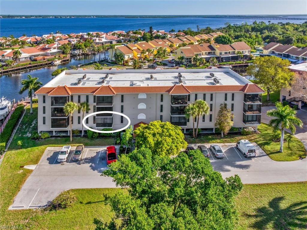 WATER VIEWS • DOCK SPACE INCLUDED • COVERED PARKING • PARTIALLY FURNISHED • GATED COMMUNITY Enjoy the Southwest Florida lifestyle in EMERALD POINTE, a gated waterfront community along the Peace River offering boating access and resort-style amenities. This 2-bedroom condo is PARTIALLY FURNISHED and features a bright, open layout with UPDATED FLOORING in the main living areas. The living space flows out to a SCREENED LANAI where you can take in WATER VIEWS and enjoy the Florida breeze. The kitchen is clean and functional with ample cabinetry, and the unit includes a STACKABLE WASHER & DRYER for added convenience. A major highlight is the INCLUDED DOCK SPACE for your boat—making it easy to get out on the water to the river and on to the GULF. The unit has storage space right outside the front door and an assigned COVERED PARKING space under the building with additional STORAGE. Building also has an ELEVATOR. Residents enjoy 3 pools, Tennis & Pickleball Courts, Clubhouse, Fitness Center, and an Active Social Calendar. Take a short walk to the community’s waterfront park and seating area along the Peace River, a perfect spot to relax or catch BEAUTIFUL SUNSETS. Location is ideal—quick access to 41 and 75--just minutes to DOWNTOWN PUNTA GORDA, Fishermen's Village, Restaurants, and PGD AIRPORT. Whether you’re looking for a seasonal retreat, full-time residence, or investment opportunity, this is a great chance to enjoy LOW-MAINTENANCE living with BOATING access in Southwest Florida.