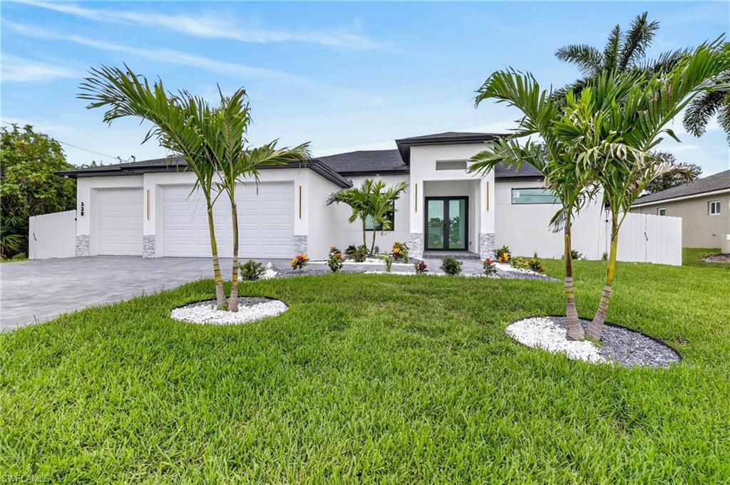 Welcome to this stunning luxury residence located in the highly desirable SW area of Cape Coral, known for its peaceful surroundings and proximity to parks, shopping, dining, and recreational amenities.

This exceptional home features 4 bedrooms, 4 full bathrooms, and a spacious triple-car garage, offering the perfect combination of elegance, comfort, and functionality. Designed for entertaining, the outdoor living area boasts a resort-style pool with spa, an outdoor kitchen, and an expansive L-shaped lanai overlooking a beautiful lake, creating the perfect setting to enjoy Florida living at its finest.

The property also includes a separate pool bathroom and laundry room for added convenience. Inside, you’ll find a modern and sophisticated design with black and white finishes, large-format white porcelain flooring, and an open-concept layout filled with natural light.

For peace of mind, the home is equipped with impact-resistant windows and doors throughout.

A rare opportunity to own a luxury waterfront home that seamlessly blends modern style, premium finishes, and breathtaking views in one of Cape Coral’s most sought-after locations.