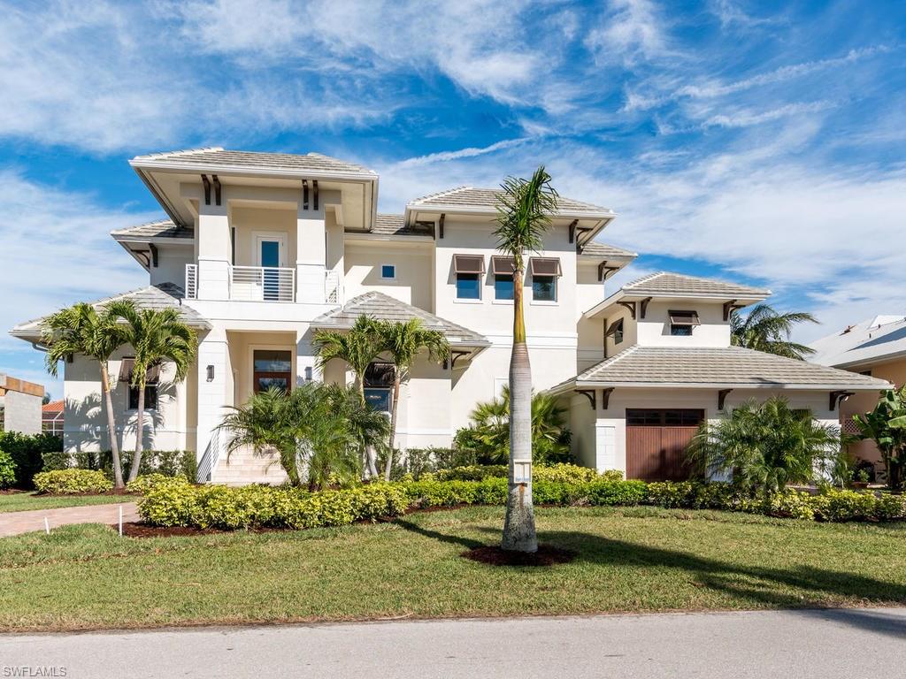 New Construction - new, never lived in waterfront home on Crane Channel within Aqualane Shores offering Naples living at its finest with an 85 ft dock to dock your vessel, which includes direct Gulf access to the Gulf of Mexico. This 4 Bedroom, 4.5 bath home offers wood /Travertine floors over-sized heated pool/spa and large deck. Eat-in kitchen and formal dining room.   Large 2nd floor covered balcony overlooking pool and canal.  Two laundry rooms. Just a short .4 miles to the white sandy beaches Naples is known for or the World Class shopping and the fine cuisine restaurants on the world famous 3rd Ave S. Historic shopping district.