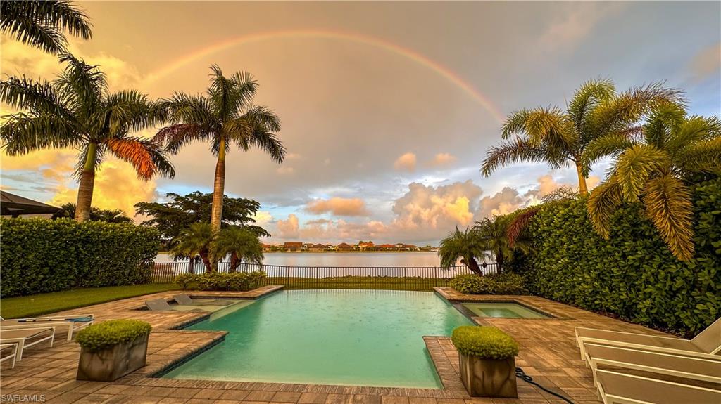 Only Clubview model available! Discover peace of mind in this beautiful residence located just 10 miles inland, providing a safe haven from coastal storms. This property has proudly weathered the last three major hurricanes in Florida ensuring you can enjoy a secure and worry-free living environment. Perfectly situated for both tranquility and convenience, this home is a must-see! Located in the exclusive, fully gated community of Corkscrew Shores in Estero, FL. Situated across from a preserve with no opposing homes, be greeted with a stunning lake view that perfectly frames breathtaking sunsets. This exquisite modern home boasts 4 bedrooms, 3 baths, plus a den, encompassing 3,077 sq-ft of luxurious living space. It features a welcoming interior and open floor plan with a harmonious mix of rustic and modern materials. A modern design that beautifully blends contemporary with classic farmhouse accents, elevated with custom barn doors.
The home features a 3-car garage, front double doors with retractable screens, wood floors, a shiplap feature wall with a Dimplex fireplace, an accent brick feature wall in the dining room, & reclaimed wood beams in the coffered ceiling of the family room & in the tray ceilings in the primary suite & den. The family room, dining room, and kitchen have impressive 12ft ceilings, with 9ft ceilings in all other areas and 8ft doors throughout. The spacious primary suite is enhanced with a spa-like bath & separate his & her closets for maximum storage. Wake up to the breathtaking water view from the comfort of your own bed from both the primary suite & bedroom 4.
The kitchen is a chef’s delight with a herringbone backsplash, an oversized island, & a built-in bar area with an under counter wine fridge making it great for entertaining. Sonos system installed to create an immersive surround sound experience. The spacious laundry room is a crafter's dream, & the garage features an epoxy floor.
Enjoy the Florida sunshine in your resort-style backyard, featuring a large negative edge pool, separately heated spa, & a pool shelf perfect for lounging. The fenced-in yard, adorned with palm trees & lush zoysia grass, is ideal for entertaining & movie nights. Lanai offers 380 sq-ft of covered outdoor space, featuring zero corner sliding glass doors, a reclaimed wood ceiling, outdoor kitchen & individual motorized lanai screens, making it perfect for relaxing, dining, & enjoying surrounded scenery. This versatile area seamlessly extends your living space. Enjoy a western view with breathtaking sunsets overlooking a serene 240-acre lake.
Amenities include a clubhouse with dining, resort-style pool/spa, gym, tennis/pickleball courts, a kayak launch, & more. Centrally located, minutes from RSW, shopping, beach, new winery & Miromar Outlets.