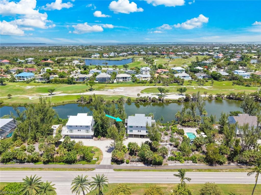 Come to Sea Pines…a small near beach community centrally located on Middle Gulf Dr. on Sanibel Island. This pet friendly community is directly across the street from the beach and includes a pool for the 5 property owners. This half duplex home offers 3 bedrooms and 3 baths in a spacious 1680 square feet of living area. In addition, to the peaceful screened lanai on the main living floor and there is an upper balcony where you will enjoy the serene beauty of the lake and wildlife between Sea Pines and the Sanibel Island Golf Course. This unit comes with covered parking under the home for 2 vehicles, a large enclosed storage/workshop on the ground level and an outdoor shower at the base of the stairs which enables you to wash the sand off before entering the home. Feel secure knowing you have impact glass windows throughout along with shutters for the sliders. Located on the main floor there is a bedroom and full bath as well as a full sized washer and dryer. Upstairs a large primary bedroom and bath just up the hallway from another guest bedroom and bath. This main bedroom features wood vaulted ceilings and a balcony where you will enjoy the beautiful sunset glow over the pines and the lake. This property location is ideal for those who would like to be near the beach access or close to nearby public restaurants (across the street at Sundial or Ibis Grill in Beachview). The nearest beach access will be at Fulgur St. just about 1/4 of a mile away. Unit C is move in ready. Bring your pet and your happy kids, and let us help you purchase your slice of paradise on Sanibel Island!