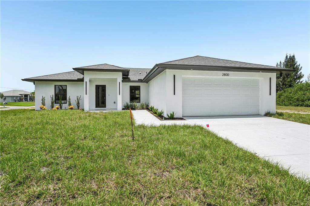 Welcome to this stunning, brand-new 2026 home, perfectly situated on an incredible oversized corner lot offering 12,818 square feet—nearly one-third of an acre. With 146 feet of frontage and roads on three sides, this rare oversized homesite offers exceptional curb appeal and an expansive setting that is rarely found with today's new construction homes. The generous side yards provide the perfect canvas to bring your vision to life. Add fencing, mature tropical trees, Clusia hedges, and lush landscaping to create the privacy you desire and transform the property into your own secluded, park-like oasis. Opportunities like this are hard to find, making this homesite just as special as the home itself.

This beautifully designed home offers over **1,658 square feet of living space** and **2,388 total square feet**, including a spacious **two-car garage**. It features four spacious bedrooms, two luxurious bathrooms, and a spectacular screened-in pool with a generous covered lanai—perfect for entertaining or simply relaxing while enjoying the desirable southwestern exposure and breathtaking Florida sunsets.

Built with quality and peace of mind, the home includes hurricane-impact windows, doors, and sliders, along with gutters in both the front and rear. The professionally landscaped yard has been enhanced with newly planted Clusia hedges that will mature into a beautiful natural privacy screen.

Step inside to an open, light-filled floor plan featuring elegant flooring, recessed LED lighting, granite countertops, luxury European-style cabinetry, and stainless steel appliances. Both bathrooms are beautifully finished with floor-to-ceiling tile, and the guest bathroom conveniently serves as a pool bath, allowing guests to step in directly after enjoying the pool.

The home is being offered **fully furnished**, making it truly move-in ready. It also includes a separate laundry room with a brand-new washer and dryer.

Another major advantage is that city water and sewer assessments are not expected for approximately the next 10 years, providing significant future savings.

Located just minutes from golf courses, shopping, restaurants, medical facilities, and everything the area has to offer, this home combines an exceptional location with luxury finishes and an oversized homesite.

**If you're looking for a brand-new, furnished home on an oversized lot with a beautiful pool, hurricane-impact protection, and an outstanding location, this is the one you've been waiting for. Schedule your private showing today and make this exceptional property yours.**