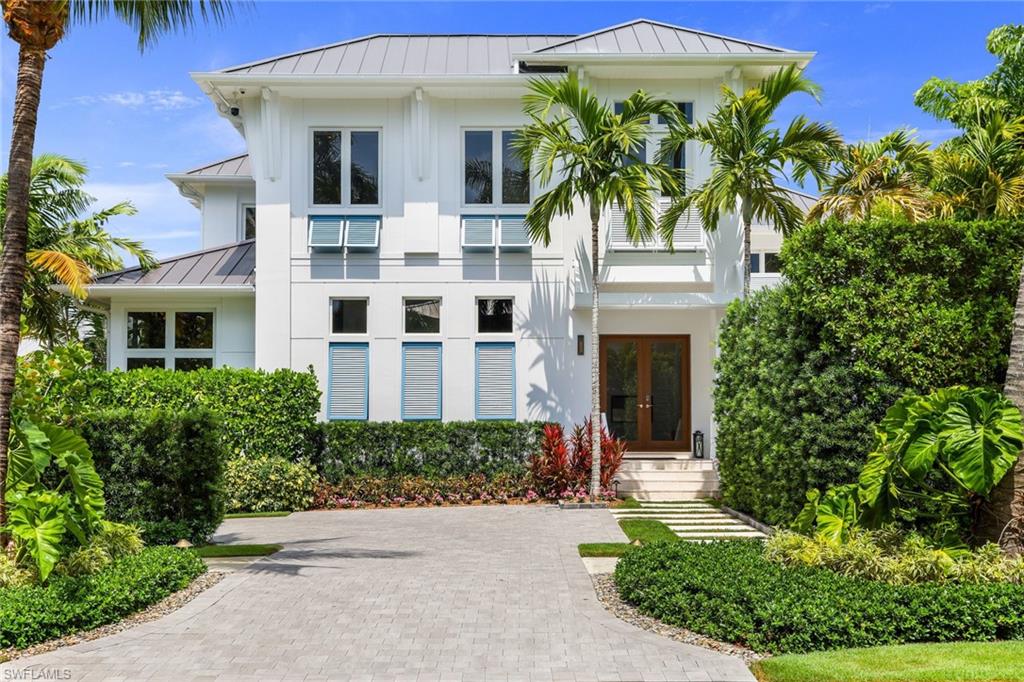 This magnificent move-in ready fully furnished MHK designed home balances a luxurious array of comforts & amenities with modern architecture that harkens back to the foundational architectural elements of classical Florida living. This comfortably elegant residence that is only 5 years young lives as grandly or as intimately as you please located only 1.5 blocks to our sugar sand beaches as well as a 2 block stroll to 5th Avenue South's acclaimed shopping & dining. Primary living areas are all on the first floor including the alluring Master Suite. 2nd floor has 4 additional ensuite bedrooms plus sunny Gathering Area & separate Study with vaulted shiplap ceilings. Outdoor living at its best! Lushly landscaped private west facing pool with water features & integrated spa, exceptional southern facing lanai area with amenities like 2-way gas fireplace, motorized rolldown screen, flat panel tv, Wolf gas grill, Sub Zero under counter fridge, serving counter & fully recessing sliding glass doors from main living areas. Full smart home state of the art automation Control-4 system & temperature controlled 400+ bottle Wine Room. To be sure a residence that will delight you. Come and enjoy!