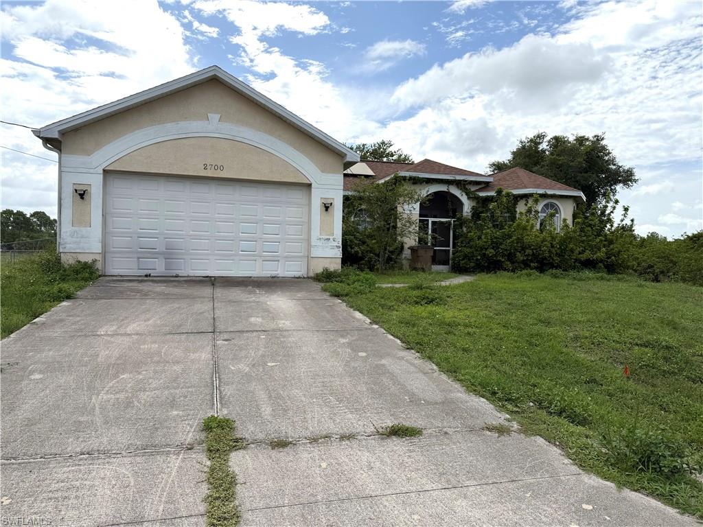 Investor special in the heart of popular West Lehigh Acres! This spacious 3-bedroom, 2-bath home offers great potential with part of the garage converted into an additional bedroom complete with A/C, perfect for guests, a home office, or extra living space. Featuring a separate dining room and separate living room, this home provides a functional layout with plenty of room to spread out.
The oversized primary suite includes a large bathroom with dual sinks, a relaxing Jacuzzi tub, separate shower, and a spacious walk-in closet. Enjoy peaceful canal views from the screened-in lanai and the privacy of the fenced backyard. Major updates include a new roof installed in 2023, and the solar panels will be fully paid off at closing for added energy efficiency and savings. Conveniently located in desirable West Lehigh Acres close to shopping, restaurants, and major roadways. Seller is accepting cash offers only.