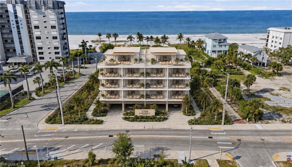 One or more photo(s) has been virtually staged, AI generated or rendered.  Positioned along one of the most visible and rapidly evolving corridors on Fort Myers Beach, 2700 Estero Boulevard presents a rare, high-exposure commercial opportunity on the coveted beachside of Estero Blvd—just a short ~300-foot stroll to the Gulf’s white sand shoreline.
Formerly home to a 14-unit boutique hotel, this cleared parcel is primed for redevelopment, offering exceptional flexibility for a wide range of luxury or mixed-use concepts. Whether envisioning an upscale boutique hotel, branded residences, or a thoughtfully curated mixed-use destination, the site delivers the scale, positioning, and surrounding momentum that sophisticated investors seek.
Directly across the street, the beautifully maintained Fort Myers Beach Library creates a serene and established backdrop, while the newly approved Myerside Resort development—featuring a dynamic mix of residential, hospitality, and curated dining—signals strong forward growth and long-term value. Seagrape Plaza is also just steps away, providing immediate access to additional retail and dining options.
The location is further enhanced by its proximity to the vibrant downtown district—just minutes away—and approximately one mile from the iconic Margaritaville Resort, placing this property within the heart of the island’s revitalization. For added convenience and accessibility, the Fort Myers Beach Shuttle’s final stop is located directly in front of the site, offering seamless connectivity for future guests or residents.
Beach Access #24, located at the end of Pompano Street, provides direct entry to the shoreline just moments away—an invaluable asset for any hospitality or residential development.
With unmatched frontage, premier visibility, and strong surrounding development activity, 2700 Estero Boulevard represents a compelling opportunity to create a landmark coastal project in one of Southwest Florida’s most sought-after beachfront markets.
