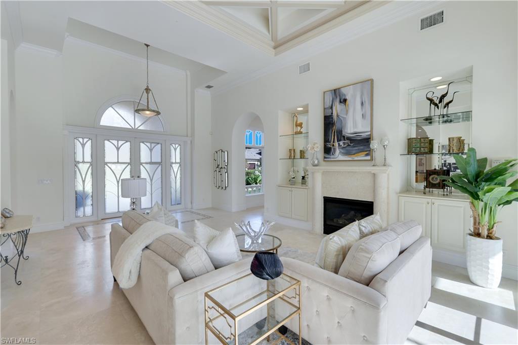 Behind 2 manned security gates lies this magnificent, expansive 4,724 sq ft under AC home on one of the largest homesites in Pelican Marsh featuring a 1,274 sq ft lanai with spacious pool, spillover spa, and large bar grilling kitchenette!  The 2 +1 car garage spaces are equipped w/a lift for a 4th vehicle. A grand total of 7,161 sq ft includes a spacious 21 x 20 upstairs bonus room, w/ full bath, large walk-in closet & Juliet balcony! Overall glamorous, timeless style combines elegance with contemporary elements, creating traditional design incorporating modern touches. Upon entering you will find the living room parlor centered around soaring picture windows & coffered ceiling, a stone gas fireplace plus a walk-in wet bar complemented by an alluring formal dining room! A cozy family room opens to an oversize island kitchen w/wrap-around breakfast bar, Sub Zero refrigerator in addition to a like new Wolf gas range. Additional features include attractive decorative windows plus several large picture windows throughout, large scale stone flooring thru main areas. Behind double doors you will enjoy your large primary suite w/reading area, surrounded by bright bay windows, plus the primary bath jetted tub, dual vanities & sitting vanity plus a water closet w/bidet & shower w/dual shower heads! Each main level guest suite features double sliding glass doors to the vast pool area along with full baths and walk in closets. Roof newly installed in April of 2022! Immersive surround sound indoors & out transforms the private outdoor pool space into your own tropical oasis! Bay Laurel master fee covers Community Center usage which  includes tennis, fitness facility, bocce, spa + new outdoor restaurant/bar for socializing! Bask at Naples' sunny beaches, enjoy watersports, shopping, movies/dining @ Mercato & Waterside Shops, nearby golf, Artis performing arts, museums & more all a short distance from your new breathtaking home in beloved Pelican Marsh!