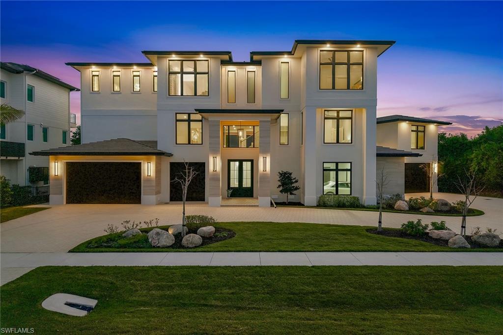 Newly completed in 2026, this landmark contemporary estate commands southern and western exposure, capturing breathtaking forever views of radiant sunsets over the Gulf’s turquoise waters and the dazzling Marco Island skyline. Conceived as a bold architectural statement and executed with uncompromising precision, this extraordinary residence embodies the pinnacle of modern coastal luxury, where dramatic design, refined elegance and effortless resort-style living converge. Offered furnished and curated to perfection, every inch reflects superior materials, intentional craftsmanship and an unwavering commitment to excellence. A private three-story elevator connects expansive indoor-outdoor living spaces framed by dramatic 10-foot sliding glass doors, while an extraordinary 10-car garage and circular drive create a grand, estate-like arrival. Ideally moments from Marco Island’s award-winning white-sand beach and adjacent to the prestigious Hideaway Beach community, where a separately purchased homesite could provide access to world-class country club amenities, the setting embodies privacy, prestige and exclusivity. Imported Incanto oak flooring from Italy flows throughout, complemented by bespoke cabinetry and curated designer finishes that elevate each space with quiet sophistication. The home offers seven bedrooms, including a private guest house, 7.5 baths, two fireplaces and four fully equipped kitchens designed for seamless entertaining on any scale. The main kitchen showcases premium Viking appliances including double ovens, gas cooktop and warming drawer, while the butler’s pantry features a built-in coffee station, wine cooler and additional refrigeration. A temperature-controlled 230-bottle wine room and a striking third-floor bourbon bar finished in Italian Galaxy Opalescent stone further distinguish the home as an entertainer’s masterpiece. The primary suite is a private sanctuary, highlighted by an extraordinary custom walk-in closet with illuminated cabinetry and a marble-topped center island, paired with a spa-inspired bath designed for relaxation and refinement. Built to exacting standards, the estate includes impact-resistant doors and windows, full storm protection, Kohler generator, tankless water heater and buried propane tank for enduring peace of mind. Outdoors, the elevated oasis is anchored by a spectacular 54-foot pool with spa, sun shelf and cascading waterfall, complemented by a fully equipped summer kitchen, all set against sweeping Gulf and skyline views that transform each evening into a private sunset performance. A dramatic suspended boat beneath the lanai ceiling adds a one-of-a-kind architectural statement. More than a residence, this is a generational estate, a rare and enduring legacy property designed to be admired, celebrated and passed forward as one of Marco Island’s extraordinary expressions of luxury living.