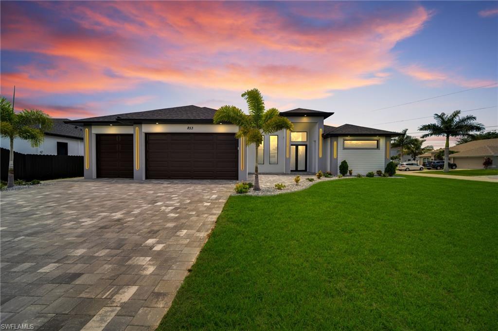 Experience luxury, comfort, and thoughtful design in this exceptional residence situated on an oversized corner lot, featuring 4 spacious bedrooms, a private office, a versatile den, 4 full bathrooms, and a conveniently located half bath. The open-concept floor plan is designed for effortless living and entertaining, with the gourmet kitchen overlooking the expansive living room and formal dining area. A built-in wine and beverage cooler and custom cabinetry add both style and functionality.

The luxurious primary suite is a private retreat with French doors leading directly to the screened pool and lanai. The spa-inspired bathroom features dual vanities, a soaking tub, a separate walk-in shower with body sprays, and two oversized walk-in closets.

Three additional bedrooms each include an en-suite bathroom and walk-in closet. A private office with French doors provides the perfect work-from-home space, while the versatile den can easily serve as a media room, playroom, or additional living area.

The outdoor living space is designed for year-round enjoyment, featuring a screened pool, spacious lanai, and a fully equipped summer kitchen with a built-in BBQ grill, cooktop, beverage cooler, and sink. A full pool bath with direct lanai access enhances convenience for outdoor living and entertaining.

Additional highlights include a spacious three-car garage and city utilities already in place. This exceptional home offers the perfect combination of elegant design, generous living spaces, and the ultimate Florida lifestyle.