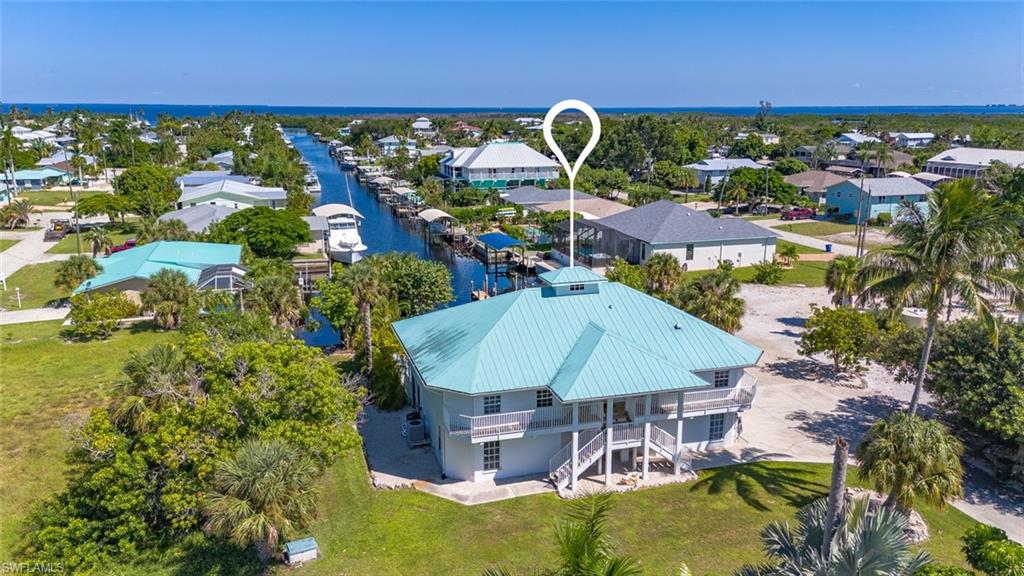 Discover an exceptional waterfront investment opportunity in beautiful Bokeelia! Situated on an almost half-acre lot with direct Gulf access, this professionally decorated, turnkey vacation rental offers the perfect blend of island living, luxury, and income-producing potential.

Nestled at the head of a deep-water canal, this stunning property provides quick access to Charlotte Harbor and the Gulf of Mexico, making it a dream destination for boaters, anglers, and nature lovers alike. Step outside and experience true island life, where manatees and dolphins are frequent visitors right in your backyard, creating an unforgettable experience for guests year-round.

Designed to accommodate large groups, the home features 5 spacious bedrooms plus a bonus Murphy bed on the upstairs patio, comfortably sleeping 16+ guests. The expansive dock offers room for multiple boats, allowing easy access to world-class fishing, shelling, island hopping, and waterfront adventures.

The outdoor living spaces are equally impressive, featuring a beautiful tiki hut, fire pit, kayaks, paddleboards, bicycles, and more—everything guests need to explore the surrounding waterways and embrace the laid-back island lifestyle.

Whether you’re seeking a personal waterfront retreat, a highly successful vacation rental, or both, this turnkey property delivers. With breathtaking views, abundant wildlife, direct Gulf access, and proven rental appeal, this is a rare opportunity to own a slice of paradise.

Schedule your private showing today and see why this remarkable island getaway continues to captivate guests and generate exceptional returns.