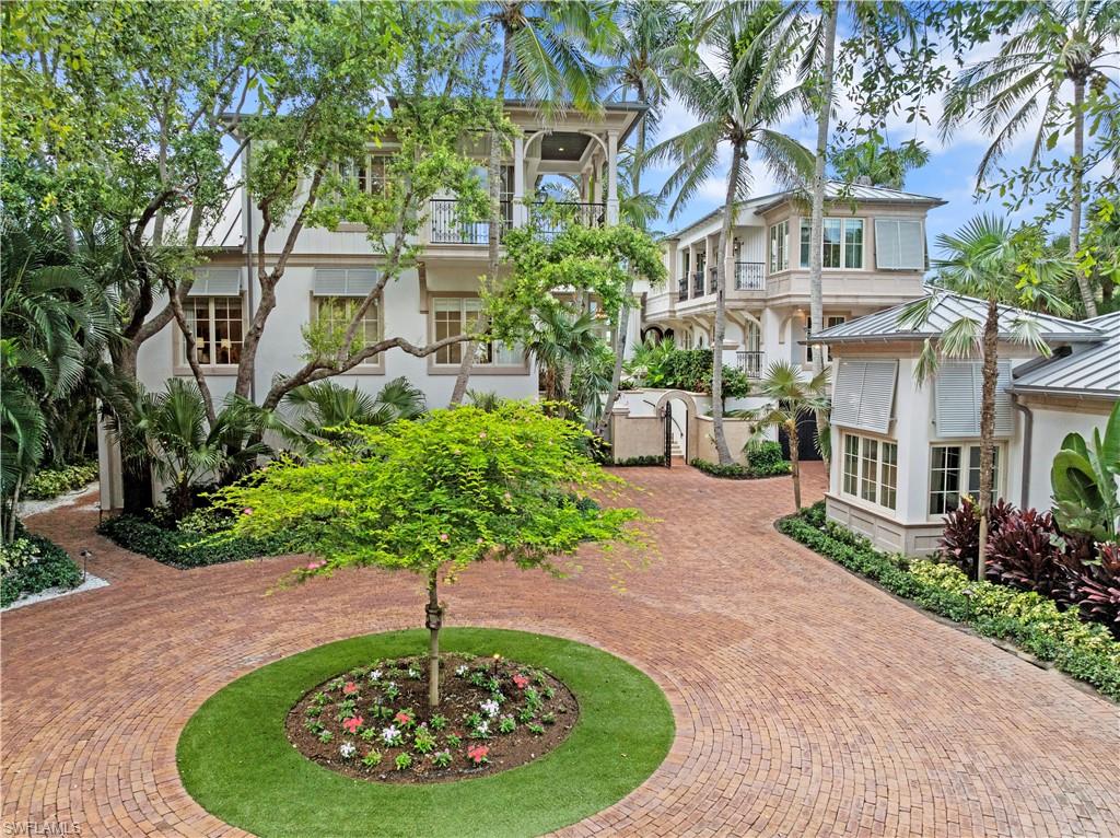 IMMEDIATE RESIDENT FULL PORT ROYAL MEMBERSHIP! Perched against the stunning backdrop of Champney Bay, this exquisite property, inspired by the aesthetics of the French West Indies, has been thoughtfully designed by the acclaimed architect Jeff Harrell. After an extensive two-year whole home renovation completed in 2022, the estate underwent a comprehensive outdoor and lower-level renovation in 2024, executed by the esteemed Knauf-Koenig Group. This remarkable multi-structure Port Royal residence boasts five bedrooms, a den, and 6.5 bathrooms, masterfully fusing timeless elegance with modern luxuries. Upon entering this captivating home, you are immediately surrounded by an array of ultra high-end finishes and contemporary details, creating an ambiance of refined sophistication throughout. The gourmet kitchen is a culinary dream, featuring premium Officine Gullo and Gaggenau appliances. The stunning primary suite, which occupies an entire level, serves as a personal retreat. It offers a private waterfront balcony, expansive mahogany walk-in closets, a convenient morning kitchen, and a lavish bathroom adorned with an exquisite mother-of-pearl domed ceiling, cultivating a serene yet luxurious atmosphere. The outdoor areas are reminiscent of a high-end resort, showcasing a magnificent pool, a peaceful koi pond, and a remarkable double-sided marble fireplace that enhances the natural beauty of the surroundings. The thoughtfully designed outdoor kitchen, private sandy beach cove in addition to private beach access off Gordon Dr, and various terraces provide an ideal setting for seamless entertaining amid lush tropical landscaping. Additionally, this home features private beach access and a dock located just a short distance from Gordon Pass allowing for direct access to the gulf, making it perfect for boating enthusiasts. For car aficionados, the estate features three garages with the capacity to accommodate up to nine vehicles or 13 vehicles with lifts. Residents enjoy exclusive membership eligibility to the prestigious Port Royal Club, adding yet another enticing aspect to this extraordinary property.