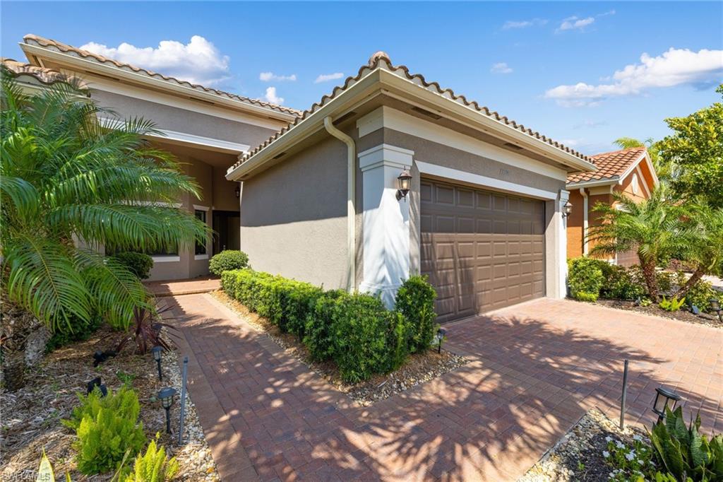LOCATION LOCATION LOCATION WILL NOT LAST LONG! This villa has it all and comes with  numerous designer upgrades and high-end appointments to include, designer lighting  & fans, stone kitchen backsplash, closet built-ins, custom kitchen, upgraded stainless appliances, a triple paneled  hurricane slider overlooking  an expansive paver patio & lake view, an electric hurricane shutters off the screened in lanai, and  if I could not get any better  this home has  upgraded travertine flooring.  The exterior  landscaping and  lighting has been upgraded and meticulously maintained.  Marbella Isles is a gated community and has a resort style  amenity center to include a community pool, fitness room, tennis, indoor outdoor basketball and a kids playing area.