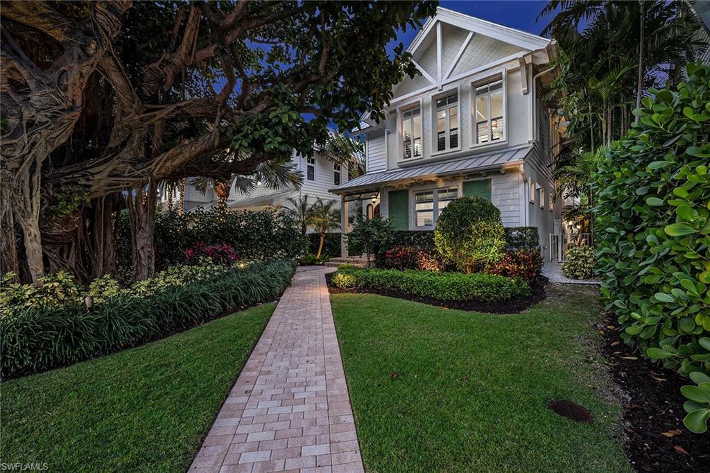 Impeccable design, unparalleled quality and a coveted location in the heart of Old Naples — welcome to 531 4th Avenue South. This architectural wonder was designed by renowned MHK Architecture and built by Waterside Builders. Echoing the Old Florida-style cottage on the outside, the inside is a showcase of modern sophistication and designer details, from floor-to-ceiling glass throughout the entire great room, coffered ceiling accents, covered outdoor living area with a kitchen and fireplace to the marble and wood flooring throughout. The gourmet kitchen exudes casual elegance and is outfitted with high-end appliances and upgrades. Enjoy the indoor/outdoor lifestyle with retractable glass sliders leading to the entertainment deck with a gas-heated pool and spa. Additional features include custom ceiling details, a two-car garage, impact-resistant doors/windows/sliders and gorgeous tropical landscaping. Your dream home awaits!