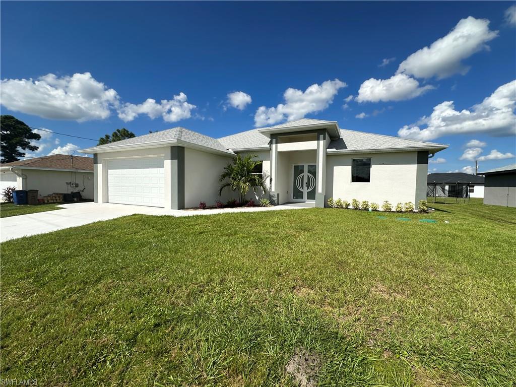 Welcome to this, ready to move in, brand-new home situated in the W Lehigh Acres neighborhood. Offering 3 spacious bedrooms, 1 Den/office, 2 stylish bathrooms, and a meticulously designed living space that perfectly combines modern aesthetics with functionality. The open-concept layout features high tray ceilings and is filled with natural light from expansive impact-resistant windows and French doors, creating a bright, airy atmosphere. The kitchen is a true standout, featuring sleek quartz countertops and backsplash, a waterfall island with trendy pendant lighting, and premium stainless-steel appliances. Luxury vinyl plank flooring flows throughout, complementing the contemporary design, perfect for entertaining. The master suite is a true retreat, complete with a dual-sink vanity, a spacious walk-in shower with a frameless glass door, and a stylish barn door to the toilet room for privacy. LED-lit mirrors and modern touches enhance the refined space. Enjoy outdoor living year-round on the covered lanai. Additional features include a 2-car garage with a motorized door for easy access and ample storage space. With easy access to Lee Blvd and Sunshine, this home offers the perfect blend of comfort, style, and convenience. NO HOA and NO FLOOD INSURANCE. Be the first to call this beautiful, brand-new home yours—schedule your private showing today!. Pictures with furniture are virtually prepared for illustrative purposes only.