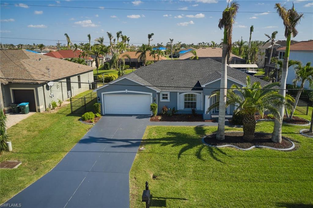 BACK ON MARKET!   Best Price for Gulf Access with LIFT.  Impressive move-in ready home offers quick Gulf access in the highly sought-after million-dollar Four Mile Cove area.   ALL TILE  wood-plank look flooring throughout the entire RENOVATED home, this property boasts new white cabinets with beautiful quartz counters, an island, and pantry cabinets.  Additionally, the home has a NEW 3.5 ton AC unit with Nest technology.   BRAND NEW ROOF   Enjoy the convenience of wood dock, lift with GEM Remote,  Cover plus concrete dock with water and electric. The yard is fully fenced and features lush landscaping with 50’ palms. Electric shutters with a remote on the pool side and easy accordion shutters on all others provide added peace of mind.  The primary bedroom features a soaking tub and separate shower, and the property has 4 bedrooms plus a den area. This home is perfect as a vacation home or rental, and guests can easily walk to shops, Publix, bowling, Starbucks, the mall, theater, and restaurants. Don't miss out on the opportunity to make this expansive 4-bedroom home with a den area your new residence! House had no hurricane damage.