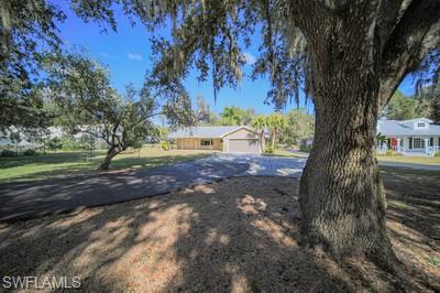 This is the "ONE"! Outdoor Nature Enjoyment!! This cozy 2297 sq ft 3-bedroom 2-bath home in a private gated community has a 2-car garage and a 550 sq ft screened lanai. It sits on an acre shaded by a dozen large oak trees, making it secluded and private, and yet only 2.5 miles from the center of town. Beautiful interior with stainless steel appliances. Large laundry room with washer & dryer. Tile & laminate floors. Ceiling fans, window coverings. The guest bath opens to lanai. Enjoy not just the home, but all its amenities. There is a large backyard with a 15' x 20' cement pad under the oak trees. The front of the house offers a 10' x 37' front porch. There is over 100 ft of driveway and extra parking for 4 cars. The landscaping is included with the rent and auto sprinklers. All water is also included. NOW, for The Club House! It has a game room with ping-pong and a pool table. There is a tennis court, basketball court, and pickleball court for you to enjoy, along with a screened-in pool. What more could you ask for. This lovely property has it all.