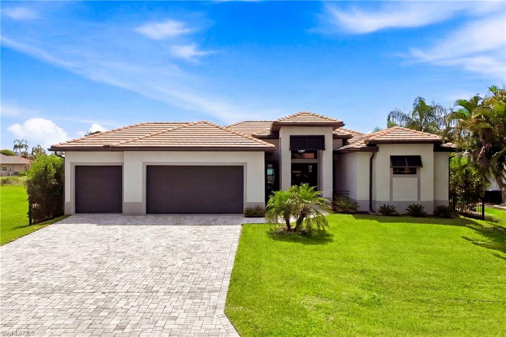 NEW CONSTRUCTION QUALITY WITHOUT THE WAIT. Built in 2023, this Gulf access waterfront pool home offers the perfect blend of modern luxury and the Southwest Florida boating lifestyle. Featuring 3 bedrooms, 3 full bathrooms, a 3 car garage, western rear exposure, and spectacular sunset views, this exceptional residence is move in ready and loaded with premium upgrades.
Since completion, the property has been thoughtfully enhanced with a composite dock featuring water and electric service, a covered 13,000 pound boat lift, privacy fencing, and professionally installed landscaping that creates a secluded backyard retreat while providing a secure area for pets and outdoor living.
Designed for entertaining, the expansive screened lanai showcases a heated saltwater pool with an integrated spa, generous paver deck, accent lighting, and a custom outdoor kitchen complete with a built in grill, refrigerator, and sink.
Inside, the open concept great room is highlighted by soaring coffered ceilings, large format porcelain tile flooring, recessed lighting, and a contemporary electric fireplace. Oversized sliding glass doors seamlessly connect the living space to the outdoor entertaining area and tranquil canal views.
The gourmet kitchen is equally impressive, featuring quartz countertops, ceiling height white cabinetry, stainless steel appliances, double wall ovens, a walk in pantry, and an oversized waterfall island that serves as the centerpiece for entertaining family and friends.
The spacious primary suite enjoys direct access to the lanai and features two walk in closets, dual vanities, a freestanding soaking tub, and an upgraded walk in shower with a built in bench and floor to ceiling tile throughout. One guest bedroom functions as a private ensuite, making it ideal for visitors or multigenerational living, while the third bedroom is conveniently located beside a full bath that also serves as the pool bath.
Additional features include impact resistant windows and doors, a tile roof, interior laundry room, fully paid water and sewer assessments, and an Enphase solar energy system with battery backup for improved energy efficiency and peace of mind.
The designer furnishings are available separately as negotiable, allowing for an easy transition into your Florida waterfront lifestyle.
With direct Gulf access, no HOA, western exposure, breathtaking sunsets, and every major upgrade already in place, this exceptional waterfront home is perfectly suited for boating, entertaining, and enjoying everything Southwest Florida has to offer.