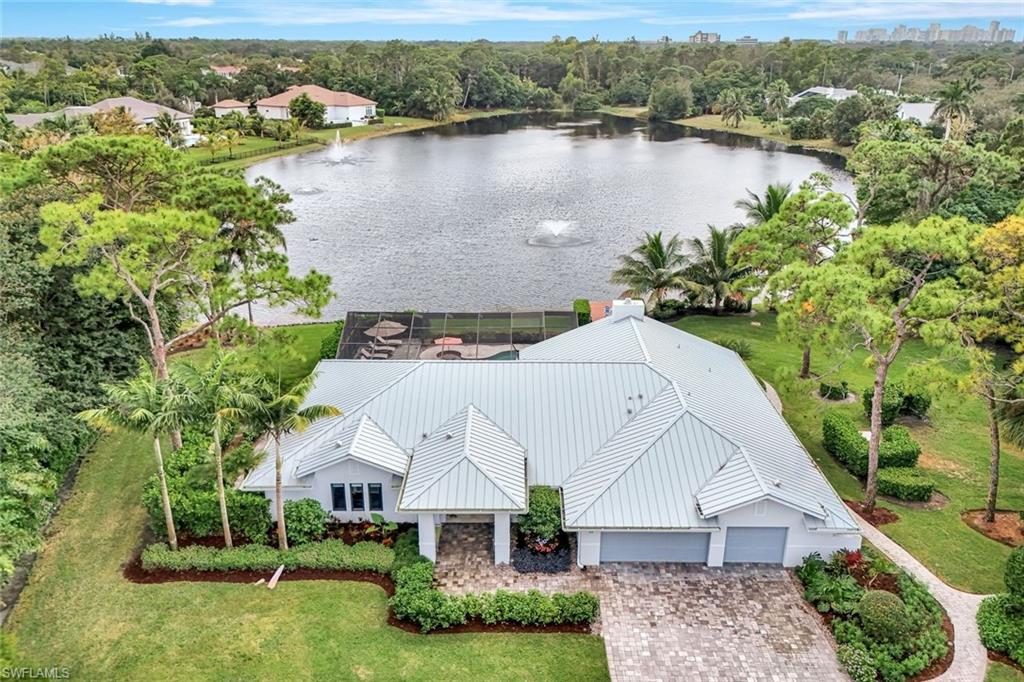 WHAT AN OUTSTANDING OPPORTUNITY NOW PRICED AT RECENTLY APPRAISED LOT VALUE!  Subline Country Living right in the heart of Naples.  This central locale offers over an acre of privacy, expansive southern lake views, 2BR guest house, and just minutes from Waterside Shops and Mercato fine dining and shopping.   This home has been totally remastered to take advantage of all the natural light.  Coastal contemporary finishes throughout offers all the advantages of a newer home to include higher ceilings, impact glass throughout, large country kitchen with fireplace, 4 bedrooms, back-up generator and 3-car garage.  The guest home has 2 bedrooms, kitchen, living area and screened in lanai.  Perfect for family living with plenty of space for grandchildren.  It also features an expansive pool deck, spa and firepit overlooking Lake Egret.  This is indeed your Naples dream home come true.  It’s a rare opportunity for a buyer to buy close to lot value but live beautifully in this unique charming home.  This needs to be seen to be appreciated.   …and The Sunsets are Free!