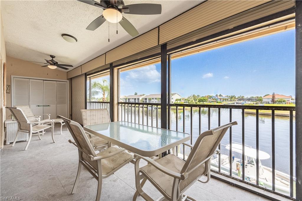 Welcome to your slice of paradise! Fully furnished and move-in ready, this beautifully maintained 2-bedroom, 2-bath second-floor waterfront condo is tucked away in a quiet Southeast Cape Coral neighborhood, where peaceful surroundings and breathtaking views take center stage.

Enjoy coveted western exposure with spectacular sunsets and sweeping intersecting canal views across an approximately 200-foot-wide Gulf-access canal. Whether you're sipping your morning coffee, watching boats cruise by, or unwinding at the end of the day, the expansive 26' x 7' screened and enclosed lanai is sure to become your favorite place to relax.

Designed with a spacious split-bedroom floor plan that lives larger than its square footage, the condo features soaring vaulted ceilings in the living room and primary suite, creating a bright and open feel. Quad pocket sliders blur the line between indoors and out, making the stunning waterfront backdrop part of your everyday living space. The oversized primary suite offers private lanai access and an en-suite bath with dual sinks and a walk-in shower, while the guest bedroom and bath provide privacy and comfort for family and friends.

Boating enthusiasts will appreciate Gulf access, the community dock where you can tie up your boat, and the canal-side pool—all just steps from your condo. Additional features include a brand-new A/C (2026), newer roof, in-residence washer and dryer, covered carport parking, ample guest parking, and reasonable condo fees.

Ideally located just minutes from downtown Cape Coral, waterfront dining, shopping, and entertainment, this condo offers the perfect opportunity to enjoy the Southwest Florida lifestyle today while adding your own personal touches over time. Whether you're looking for a year-round home, seasonal retreat, or investment opportunity, the location, waterfront setting, and unforgettable views make this one truly special.
