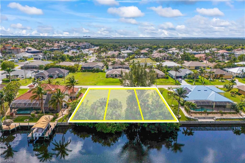 Prime Gulf Access Triple Lot – A Rare 130’ Waterfront Masterpiece in Southwest Cape Coral. Discover the pinnacle of waterfront living with this sprawling oversized parcel, situated in one of the most prestigious luxury-home enclaves near Cape Harbour. While the typical Cape Coral lot offers a standard 80’ of width, this massive triple-site boasts an incredible 130’ of water frontage and 125’ of depth, providing a level of scale and architectural freedom that is nearly impossible to find. This expansive footprint isn't just about size—it’s about possibility. The generous 0.37-acre dimensions easily accommodate a large, luxury home design, including a 4-car garage and a pool deck. Boaters will immediately recognize the value of the 130’ frontage, offering a blank slate to engineer a custom, high-capacity seawall and an oversized dock configuration designed for large vessels. Positioned along wide, intersecting canals with a scenic route to the Gulf, you are perfectly situated just minutes from the high-end dining, shopping, and vibrant marina life at Cape Harbour. Whether you envision a modern coastal villa or a sprawling tropical retreat, this rare triple-lot offers the space and the setting to bring your ultimate Florida legacy to life. Embrace the scale you deserve—where your backyard becomes a private resort and every evening ends with a sunset cruise. City water, sewer, and irrigation assessments PAID IN FULL.