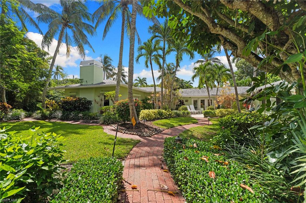 In the heart of Old Naples, 280 4th Avenue North sits on one of the largest and sought-after corner lots in the neighborhood — an expansive half-acre parcel (162 by 150 feet) surrounded by lush, manicured tropical landscaping. The original 1953 cottage evokes timeless Florida charm, while the grounds offer endless possibilities for creating your dream estate. Ideally just steps from Naples white-sand beaches, a few blocks to the new Four Seasons and its world-class amenities, and moments from Fifth Avenue South’s fine dining and boutiques, this property presents a rare opportunity to own a premier piece of Old Naples. Whether restoring the existing residence or designing a new masterpiece, the potential here is exceptional.