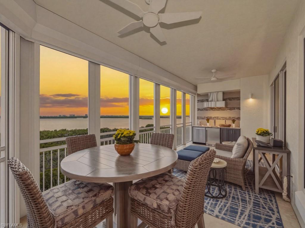 Set high above Bonita Bay’s scenic coastline, this stunning, furnished ninth-floor residence offers front-row seats to sweeping Bay and Gulf sunset views. Reimagined with a full-scale renovation and thoughtfully redesigned floor plan, this home spans over 3,500 square feet of living area and features 3 bedrooms and 3 baths. Designer fixtures, custom built-ins, and contemporary finishes create an elevated feel, while expansive sliders frame the ever-changing water views. At the center of the home, the kitchen blends beauty with function, featuring abundant custom cabinetry, a generous island, high-end stainless steel appliances, and granite countertops. The space transitions seamlessly into the dining area, where a refined gallery-style bar with beverage refrigerator enhances the home’s entertaining appeal. Outdoor living is ample across three private balcony spaces. The main screened lanai, complete with electric shutters, outdoor kitchen, and bar with a kegerator, offers an exceptional setting for alfresco dining and sunset gatherings. Rare electric roll-up retractable screens further enhance the lanai, allowing you to enjoy unobstructed panoramic views. The primary suite is a peaceful retreat, with stunning Gulf and bay vistas, dual walk-in closets, soaking tub, walk-in shower, and dual vanities. Additional highlights include a spacious laundry room, a secure private elevator foyer, two private garage parking spaces, and a dedicated storage unit. Residents of Tavira enjoy an exceptional range of amenities, including a resort-style pool and spa, fitness center, theater, game and billiard room, poolside cabana, BBQ area, and a rooftop terrace. As a resident of Bonita Bay, you'll enjoy exclusive access to a wealth of amenities including a private beach park, the popular Backwater Jack's Restaurant, and several community parks. Riverwalk Park offers a kayak, canoe, and boat launch, along with pickleball and tennis courts for active living. For golf enthusiasts, there’s an opportunity to join the Country Club, which boasts five championship golf courses, a sports/racquet center with a resort-style pool, and a state-of-the-art fitness facility, along with a luxury spa and salon. This is more than a residence, it is an elevated coastal sanctuary in one of Bonita Bay’s most sought-after luxury high-rises.