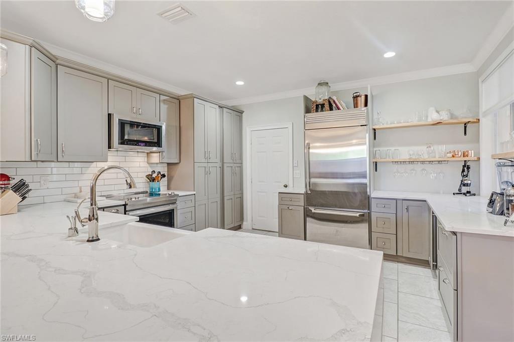 C.16526 - Wait till you see this one!! This home has been completely remodeled and updated!  One of a kind home at the Colonnade!  Owners have upgraded every room in the home!  Look at that Kitchen!  No detail has been overlooked.  Beautiful quartz counter tops that extend to the new tiled flooring with additional new cabinets, new pantry, and upgraded stainless appliances!  All new master bathroom including new larger tiled shower, new soaking tub, new above cabinet bowl sinks, and new cabinets.  All new tiled guest bathroom!  Every room has new crown molding and four inch baseboards.  All new window treatments!  Large upstairs family room has new built-in bookcase.  Notice all the new high end lighting and fan fixtures.  Home has been completely repainted with decorator assistance.  New Garage flooring!  Large lanai with storage. You wont want to miss this one of a kind home at an unbelievable low price.