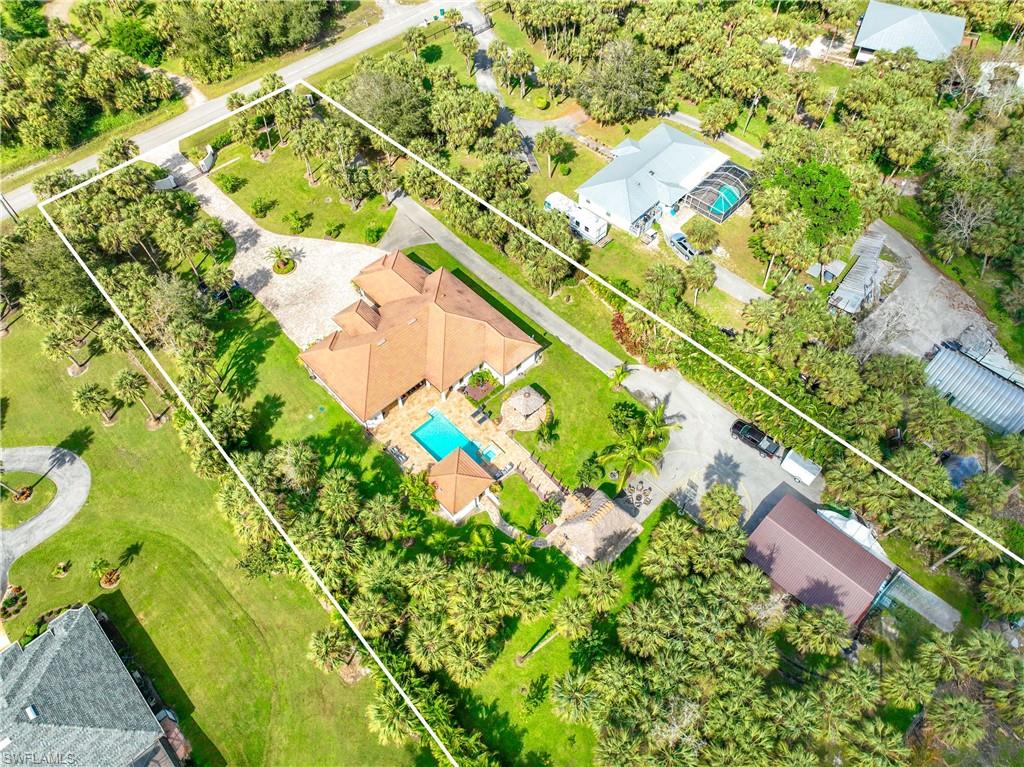Luxury Resort Living & Privacy at Its Best! Located on 2.73 Acres in The Estates, Experience the epitome of privacy, luxury, and convenience in this exceptional estate. Nestled on 2.73 acres of meticulously landscaped grounds, this home is a true oasis, offering the finest in modern living combined with ultimate privacy. The fully automated, state-of-the-art security system, two gated entryways, ensures privacy and security while offering ease of access without HOA restriction. A 30x40 detached metal storage building, fully insulated, provides ample space for all your toys, tools, or additional storage needs. Enjoy year-round comfort with two new AC units 2026 , each with a custom thermostat in each bedroom for personalized climate control. The home features an electrical panel connection for a generator, ensuring you're prepared for any situation. The automated irrigation system keeps the lush landscaping pristine with minimal effort. The stunning Interior features High trey ceilings and custom details throughout creating an open, airy ambiance. The spacious formal dining room is perfect for hosting gatherings in style, and the chef-inspired kitchen is a true highlight, featuring granite countertops, stainless steel appliances, and a large central island—ideal for meal prep or casual entertaining. The luxurious master bedroom offers an expansive retreat with custom closets and a spa-inspired master bath with granite countertops, and a walk-in shower. All bedrooms feature custom closets, TWO MASTER ROOM offering generous storage space and a personalized touch. Elegant porcelain tile runs seamlessly through the home, offering a stylish, low-maintenance flooring solution that complements the overall design. The entire home is wired for SONOS surround sound, both inside and out, ensuring you enjoy your favorite music in every room, including the pool area. Step into your personal paradise with a luxurious swim-up Bar pool, a fully equipped outdoor kitchen, and a Tiki area perfect for entertaining or simply unwinding in style. and expansive outdoor amenities make this a one-of-a-kind property, reverse osmosis and more. This stunning estate offers the ideal balance of luxury, convenience, and privacy. Whether you're hosting friends in your resort-style backyard, retreating to the sanctuary of your master suite, or enjoying the high-end finishes throughout, this property provides the lifestyle you've always dreamed of.