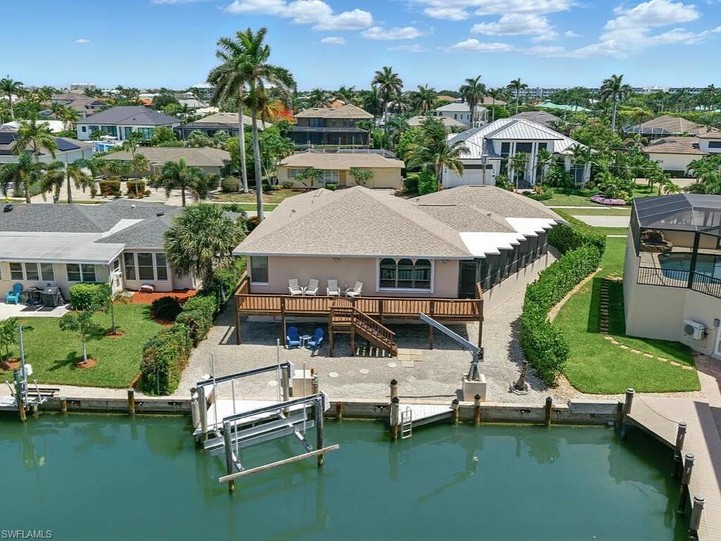 Enjoy island living in this charming 3-bedroom, 2.5-bath house located on beautiful Marco Island. This home offers direct Gulf access via Collier Bay at the end of the canal, complete with a private dock and a 12,000-pound boat lift—perfect for boating enthusiasts. Featuring an open layout floor plan, the interior flows seamlessly for comfortable living and entertaining. Additional highlights include an air conditioning storage room conveniently located in the two-car garage. Just minutes from white sandy beaches, excellent restaurants, and shopping at the Esplanade, this home offers the perfect blend of convenience and coastal charm. Prime location near Residents Beach and the Esplanade. Close to dining, shopping, and all the amenities Marco Island has to offer. If you’re looking for a long-term rental, this conveniently located home puts you right in the heart of paradise.