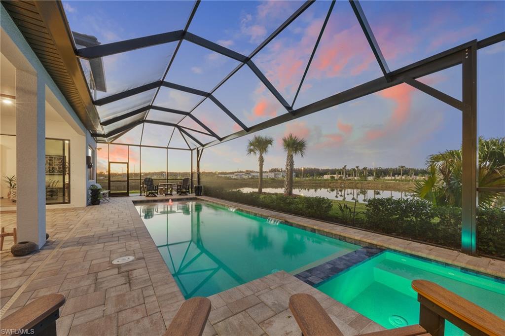 This exceptional 2023 lakefront estate offers refined luxury living in the heart of Ave Maria. Boasting 4,769 square feet of living space, this expansive two-story residence features six spacious bedrooms, six full bathrooms, and an upstairs loft, making it ideal for large families or multigenerational living. Positioned on a premium cul-de-sac lot, the home offers a private setting with minimal traffic while enjoying rare wraparound water views, with the lake extending behind and along the left side of the property, creating a truly picturesque waterfront setting.

The home is conveniently located within walking distance to both private and public schools, along with some of Ave Maria’s most desirable destinations including Ave Maria Church, Ave Maria Water Park, and North Park. The thoughtfully designed floor plan blends comfort and sophistication, featuring abundant natural light and premium luxury vinyl plank flooring throughout the main living areas. The gourmet kitchen serves as the centerpiece of the home, complete with upgraded appliances, a large center island, walk-in pantry and electric cooktop, perfect for both entertaining and everyday living.

Designed with flexibility in mind, the home offers two primary suite options, one on each level. The luxurious primary suite includes a sitting area and a spa-inspired bath with dual sinks, a soaking tub, separate shower, and spacious walk-in closets. The first floor also features an additional bedroom with a private en-suite bath, along with a dedicated full pool bath for added convenience. Upstairs, four generously sized bedrooms each include their own en-suite bathrooms, ensuring comfort and privacy for all, while the spacious loft provides an additional living or entertainment area.

Additional premium upgrades include automatic roller shades, a whole-home water filtration system, UV lighting within the HVAC system for enhanced air quality, and an ozone washer and dryer for elevated laundry care. Outdoor living is truly exceptional. Step onto the extended paver deck and enjoy breathtaking sunset views from the screened-in pool and lanai, surrounded by serene panoramic water vistas. A beautifully designed pergola above the garage adds distinctive architectural charm and enhances curb appeal.

Completing the home is a three-car attached garage, paved driveway, reclaimed irrigation system, durable concrete block construction, and a classic tile roof—offering both elegance and long-term durability. The HOA includes lawn maintenance and exterior pest control, adding convenience and peace of mind for homeowners. Located within Ave Maria’s award-winning master-planned community, residents enjoy resort-style amenities including a community pool, fitness center, tennis courts, basketball, volleyball, playgrounds, and scenic walking and biking paths. Most furnishings are negotiable, presenting a rare turnkey opportunity to own one of the finest luxury lakefront homes in Ave Maria.