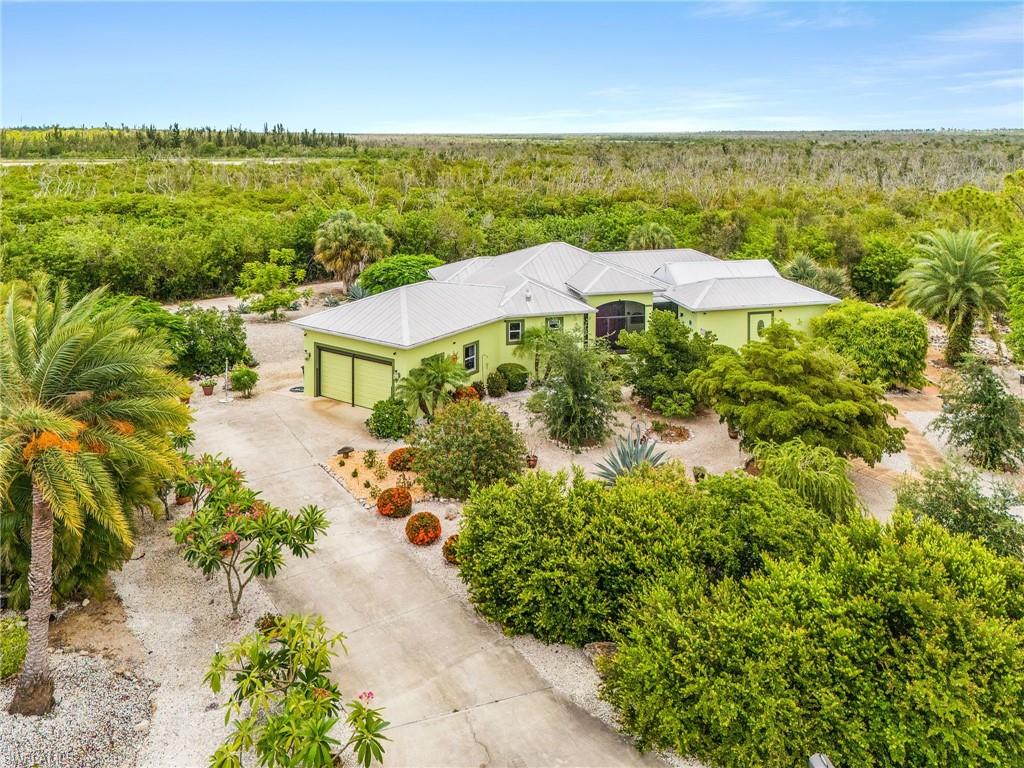 Just over an Acre of Pure Island Serenity! 

Nestled at the end of the cul-da-sac for total privacy, this beautifully landscaped property offers a unique courtyard-style layout with a separate cabana and the perfect blend of privacy, comfort, and natural beauty. Overlooking a peaceful zen pond, you'll enjoy views and a tranquil setting that feels like your own private retreat.

The spacious residence features 3 generously sized bedrooms, a well-appointed kitchen, and inviting living spaces designed for relaxed island living. A separate casita with its own full bath provides the perfect accommodations for guests, extended family, a home office, or creative studio.

Step outside to the expansive deck overlooking the water—an ideal place to enjoy your morning coffee, evening cocktails, or simply unwind while watching nature unfold around you. The lush, low-maintenance landscaping creates a park-like setting with plenty of room for pets, gardening, or outdoor activities.

Built for peace of mind, this home has never flooded and includes a newly installed state-of-the-art flood barrier system, an assumable flood insurance policy, and a durable metal roof designed to provide years of protection. Additional features include a whole-house water treatment system, elaborate irrigation system, and wheelchair-accessible access to the home.

If you've been searching for a private island oasis with room to breathe, serene water views, and versatility, this one-of-a-kind property is not to be missed.