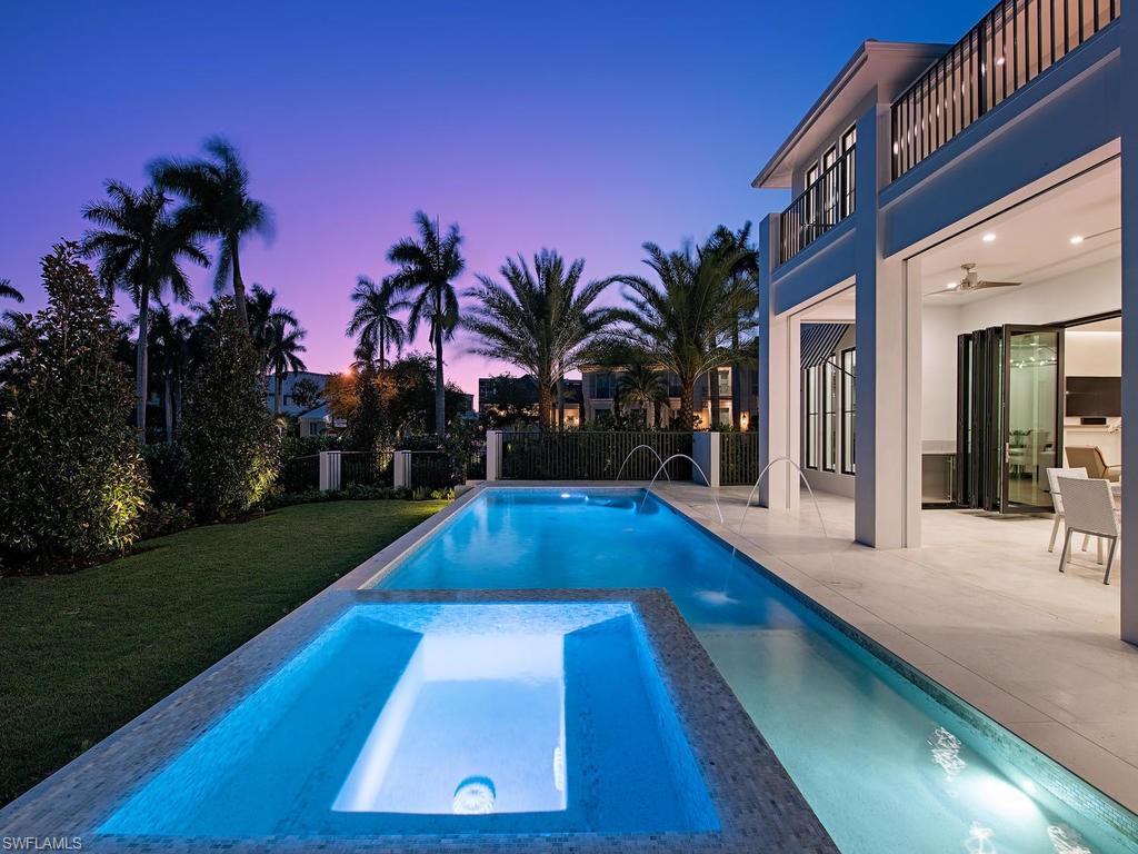 Beautiful new custom home in The Moorings with southern exposure on pool! Very spacious great-room plan with floor to ceiling Grabill Cabinetry in Kitchen and Service Kitchen. Master Wing includes: large master bathroom with two water closets, two master closets, and sitting area bedroom. Enjoy the outdoor living with over-sized pool deck that has sun all day, gas heated pool and spa, gas fireplace, outdoor BBQ grill and under-counter refrigerator and ice maker, electric screens & shutters and pool bath. Upgrades Include: Residential Elevator, Legno Bastone herringbone wood floor with border in Main Living Room, Foyer, Kitchen, Grabill Custom Cabinets, Sub-zero Integrated Refrigerator/Freezer and 48" Wolf Gas Cooktop, Sub-zero refrigerator drawers, stand-a-lone ice maker. Service Kitchen includes: Wolf Steam Oven, wall oven, warming drawer.  Custom ceiling beam work, security system, central vac system, camera system, Cinema ceiling speakers and pre-wire for surround sound in great room, and control 4 lighting system in main living area and master suite.  Private Mooring Beach available!