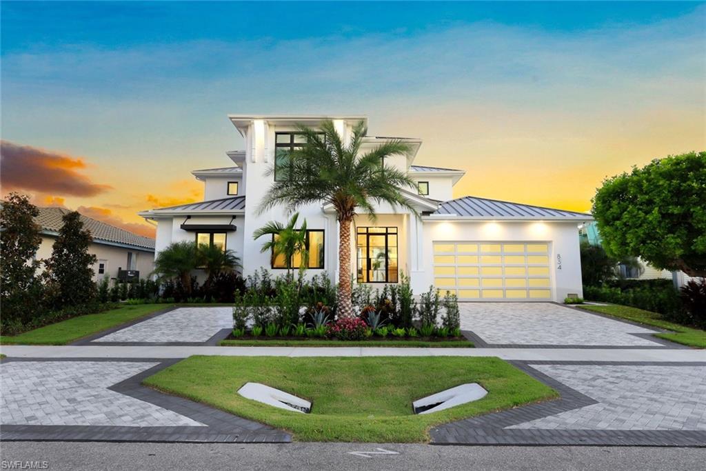 Newly built waterfront home at Marco’s South End, features wide plank French Oak floors with a glass-enclosed office. The two-story living area with Zero-corner sliders and transom windows facilitate indoor-outdoor living. The Ground floor primary features access to pool and spa. Three upper-level ensuite bedrooms, with a built-in bunk room, share a waterfront lanai. The open-plan great room integrates formal dining with modern furnishings and fixtures. The Gourmet kitchen includes a Wolf Range, Thermador fridge, wine fridge, Quartz countertops, and center island with farm sink to complete the space. Adjacent are a guest/pool bath and laundry room. The ground floor primary suite features a spa-like bathroom with freestanding tub, walk-in shower, separate dual sinks, a dressing area vanity and his and hers walk-in closets. Alfresco dining on the lanai features retractable screens and Wi-Fi. All windows and doors are impact glass. The pool deck features an in-ground pool with attached spa, and elegant stairs to the waterfront with direct Gulf access. A circular driveway and three-car garage, security systems and a 22KW whole house generator ensure continuity and comfort.